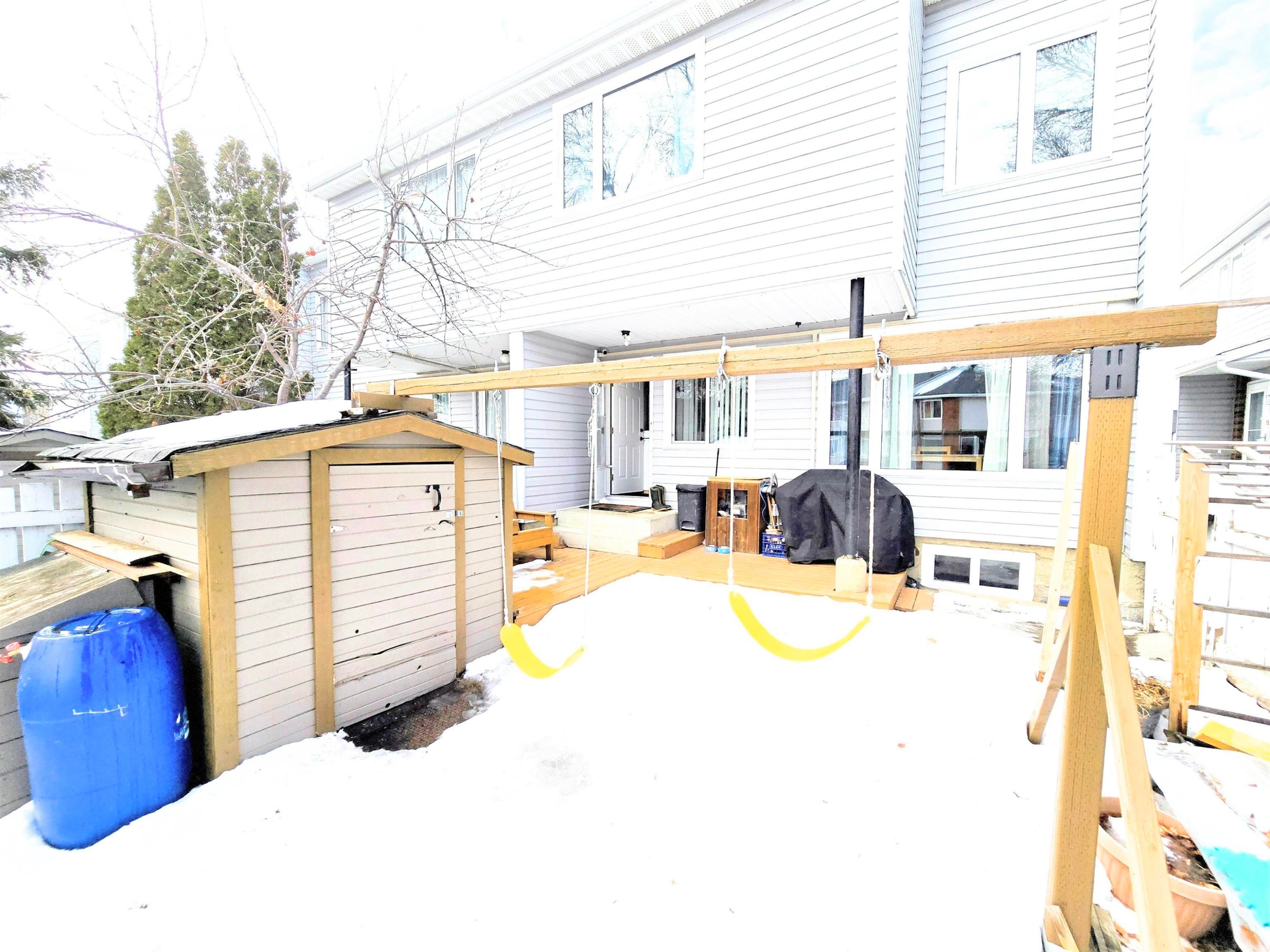 Rear view of house featuring a storage unit and a patio - 80 Amberly Crest, Edmonton, AB - Outdoor With Exterior