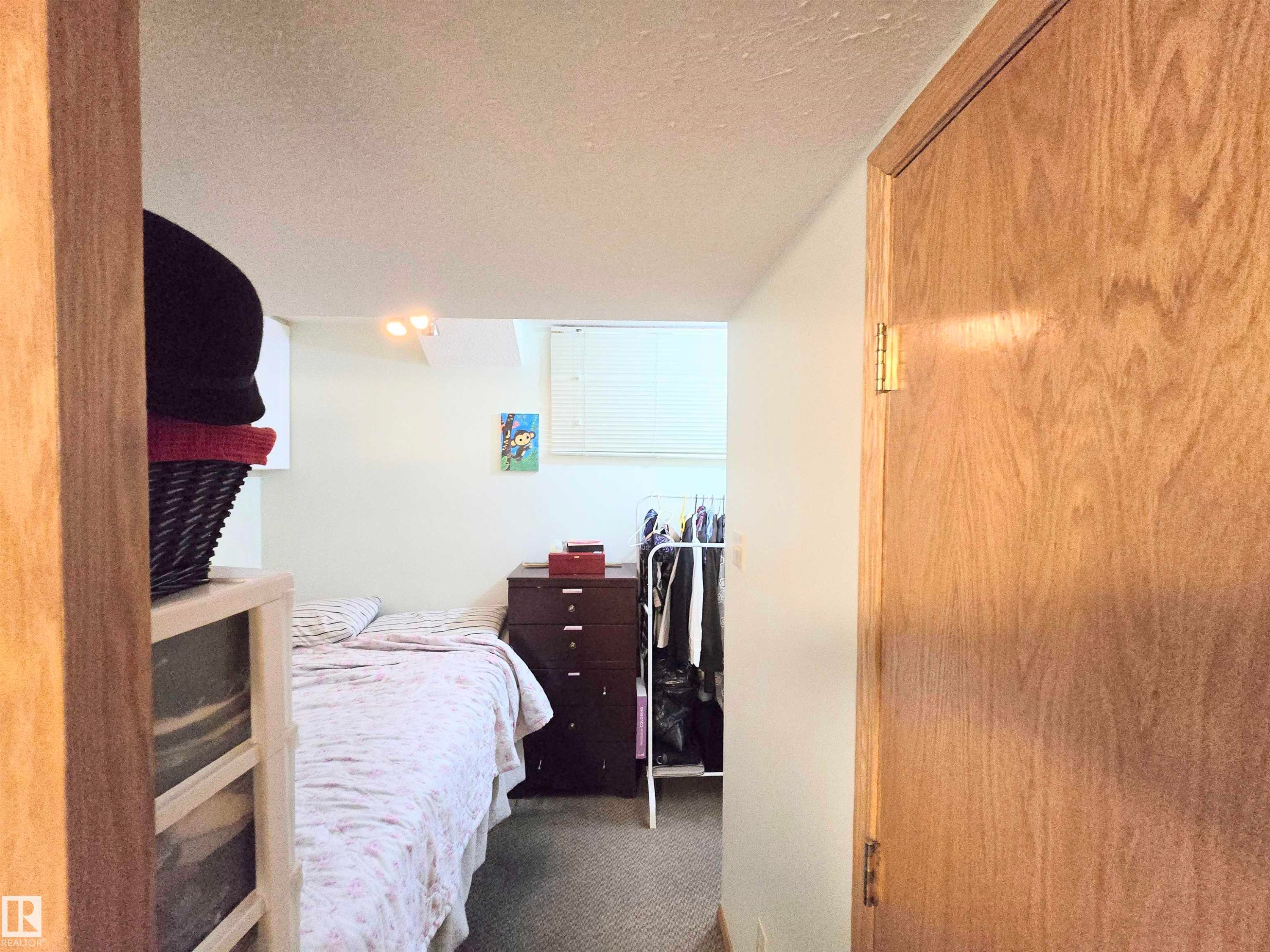 Carpeted bedroom featuring a textured ceiling - 2 4403 Riverbend Road, Edmonton, AB - Indoor Photo Showing Bedroom