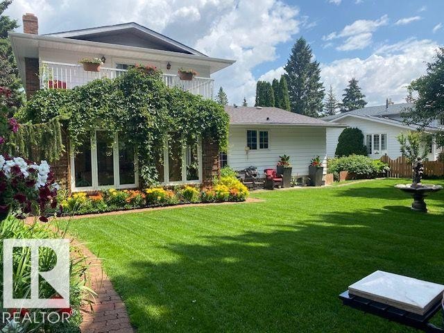 Back of property with a yard, a balcony, and a chimney - 206 Wolf Willow Crescent, Edmonton, AB - Outdoor