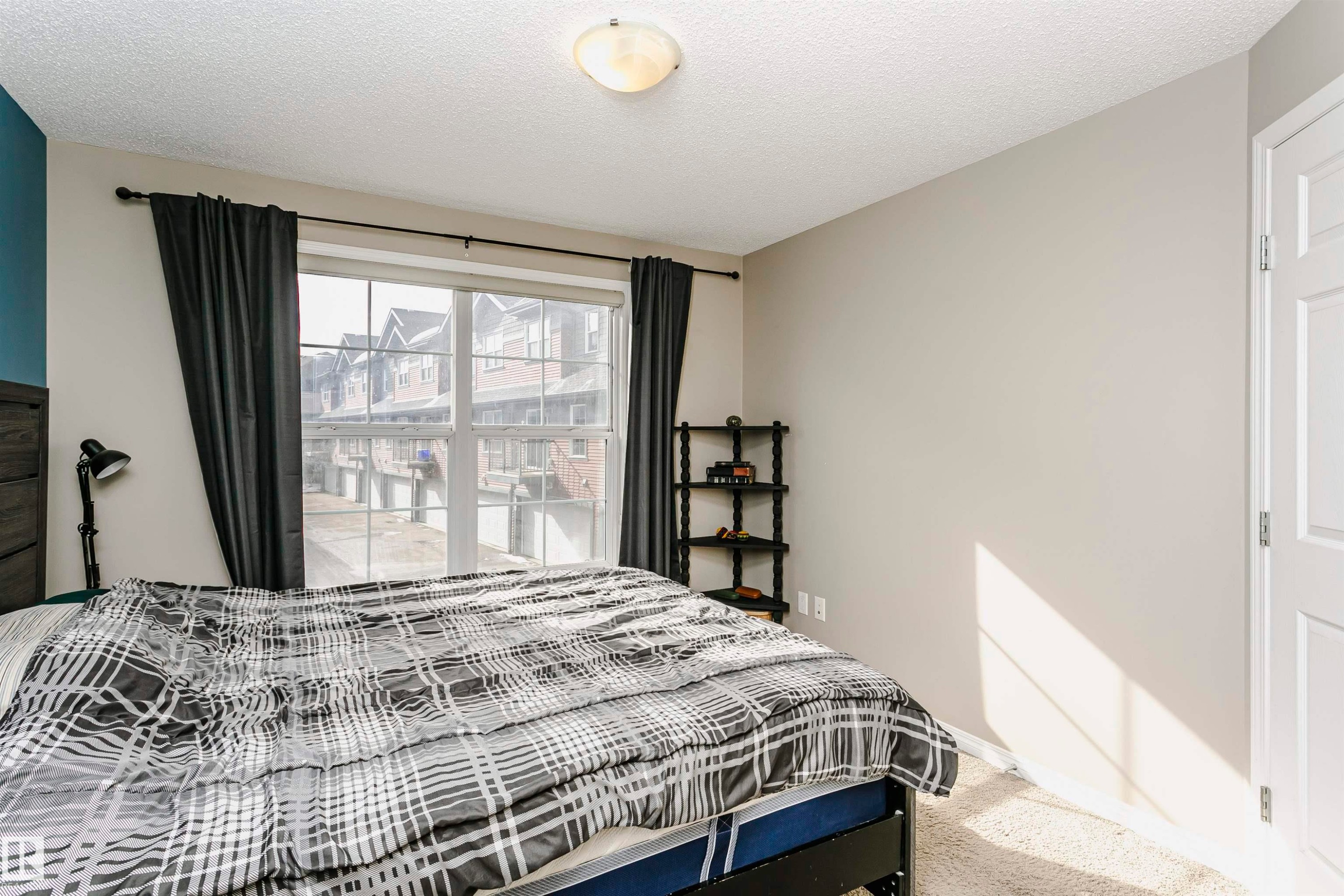 Bedroom featuring light colored carpet and a textured ceiling - 4011 Orchards Drive, Edmonton, AB - Indoor Photo Showing Bedroom