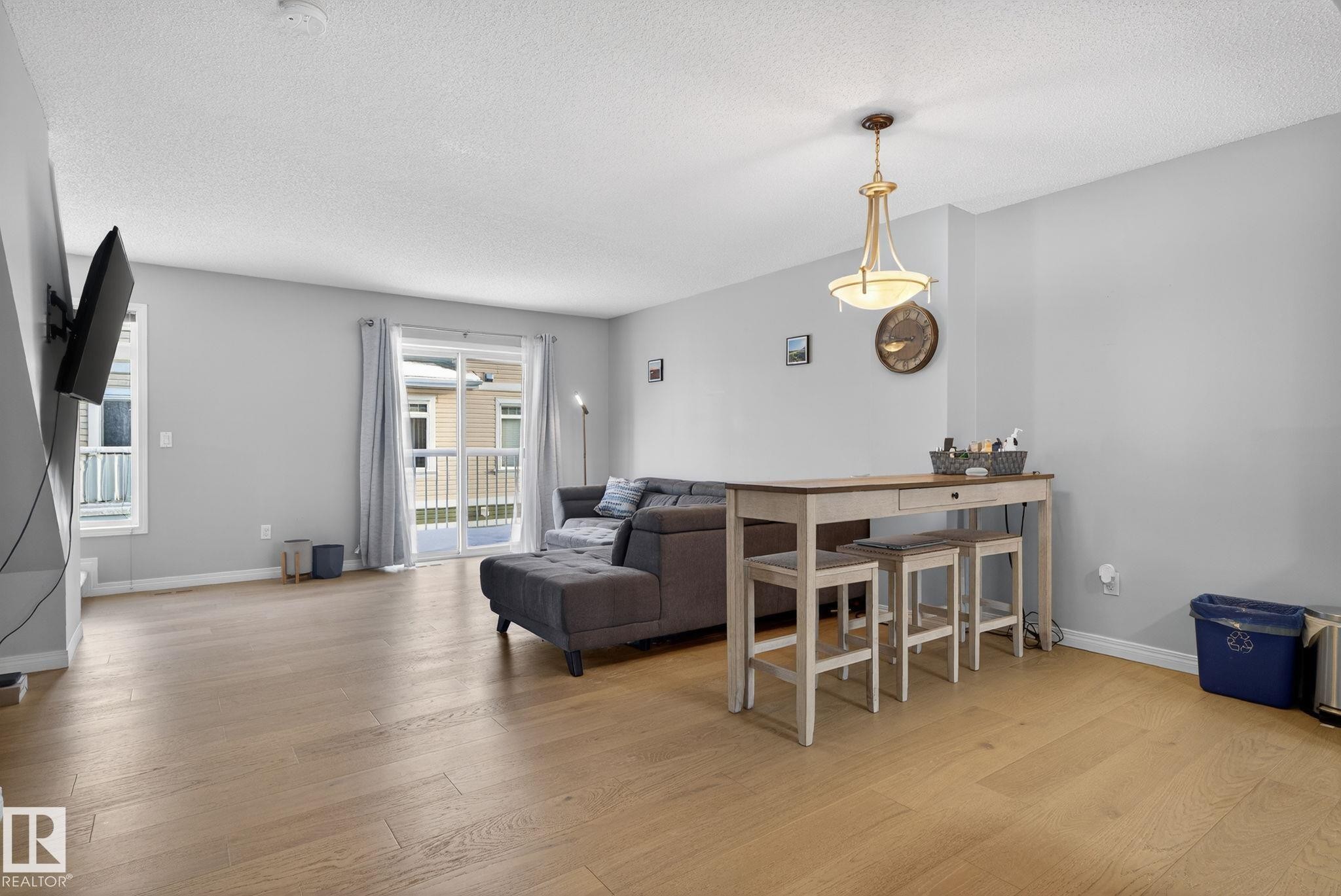 Dining space with light wood-type flooring and a textured ceiling - 60 1804 70 Street, Edmonton, AB - Indoor