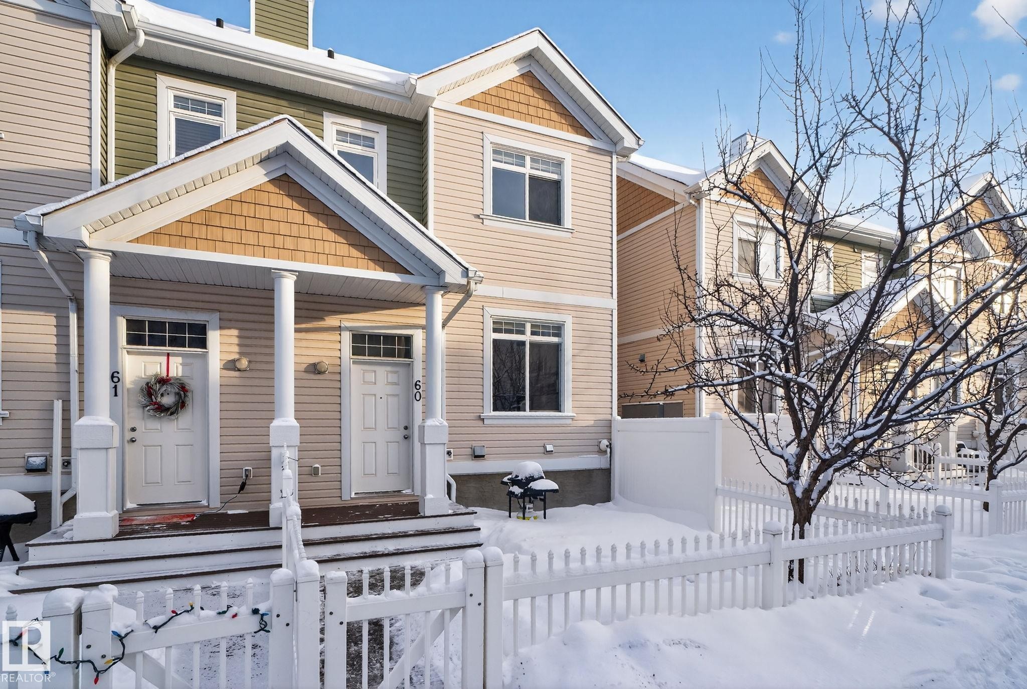 View of front of property with a fenced front yard, covered porch, a gate, and a chimney - 60 1804 70 Street, Edmonton, AB - Outdoor