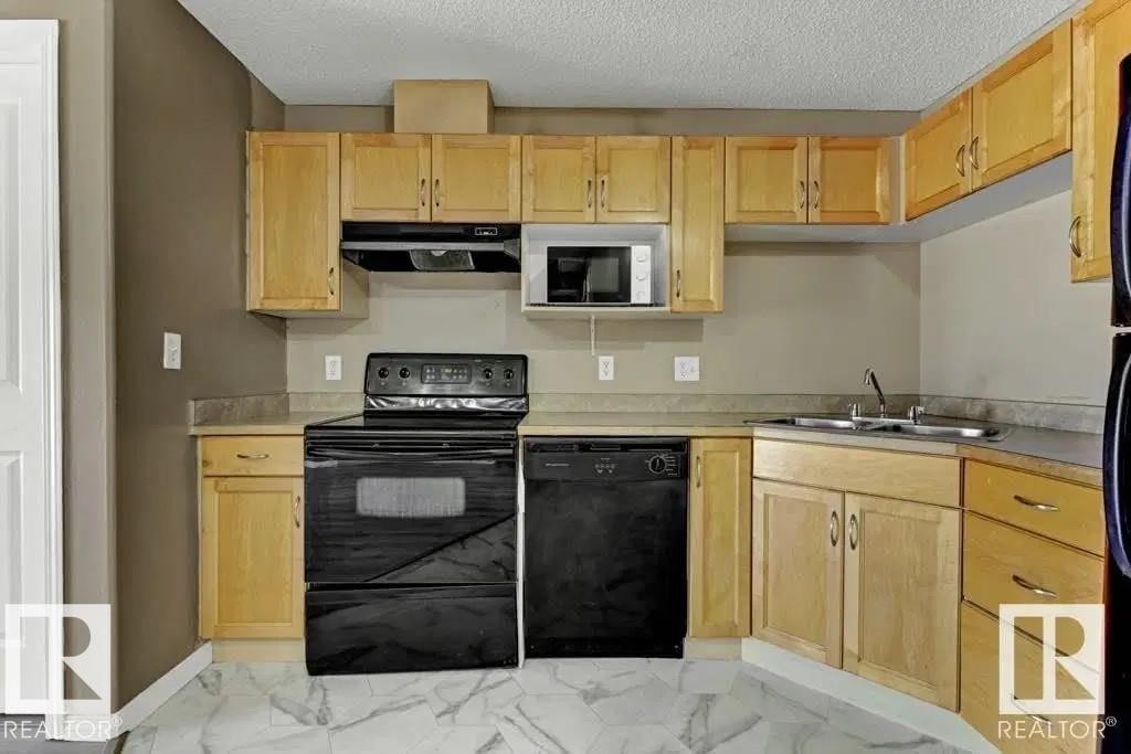 211 245 Edwards Dr Sw, Edmonton, AB - Indoor Photo Showing Kitchen With Double Sink