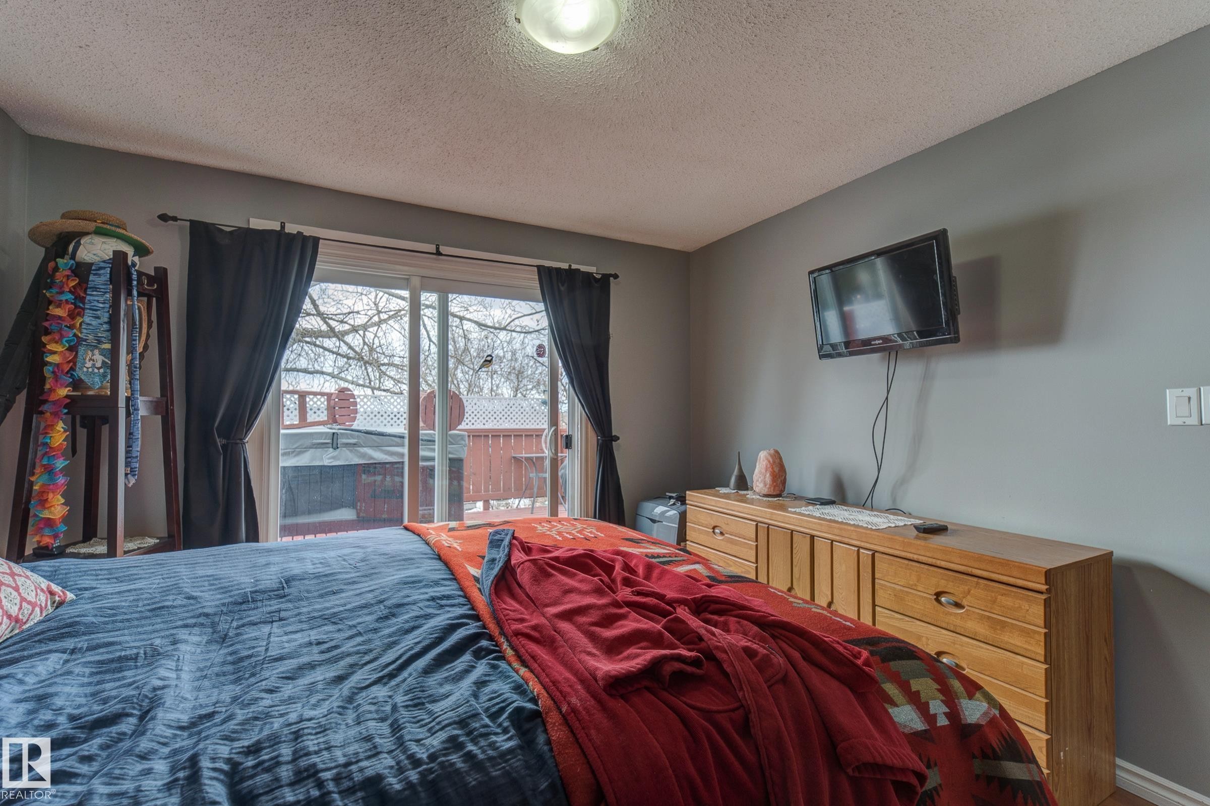 Bedroom featuring access to outside and a textured ceiling - 4823 10 Avenue, Edmonton, AB - Indoor Photo Showing Bedroom