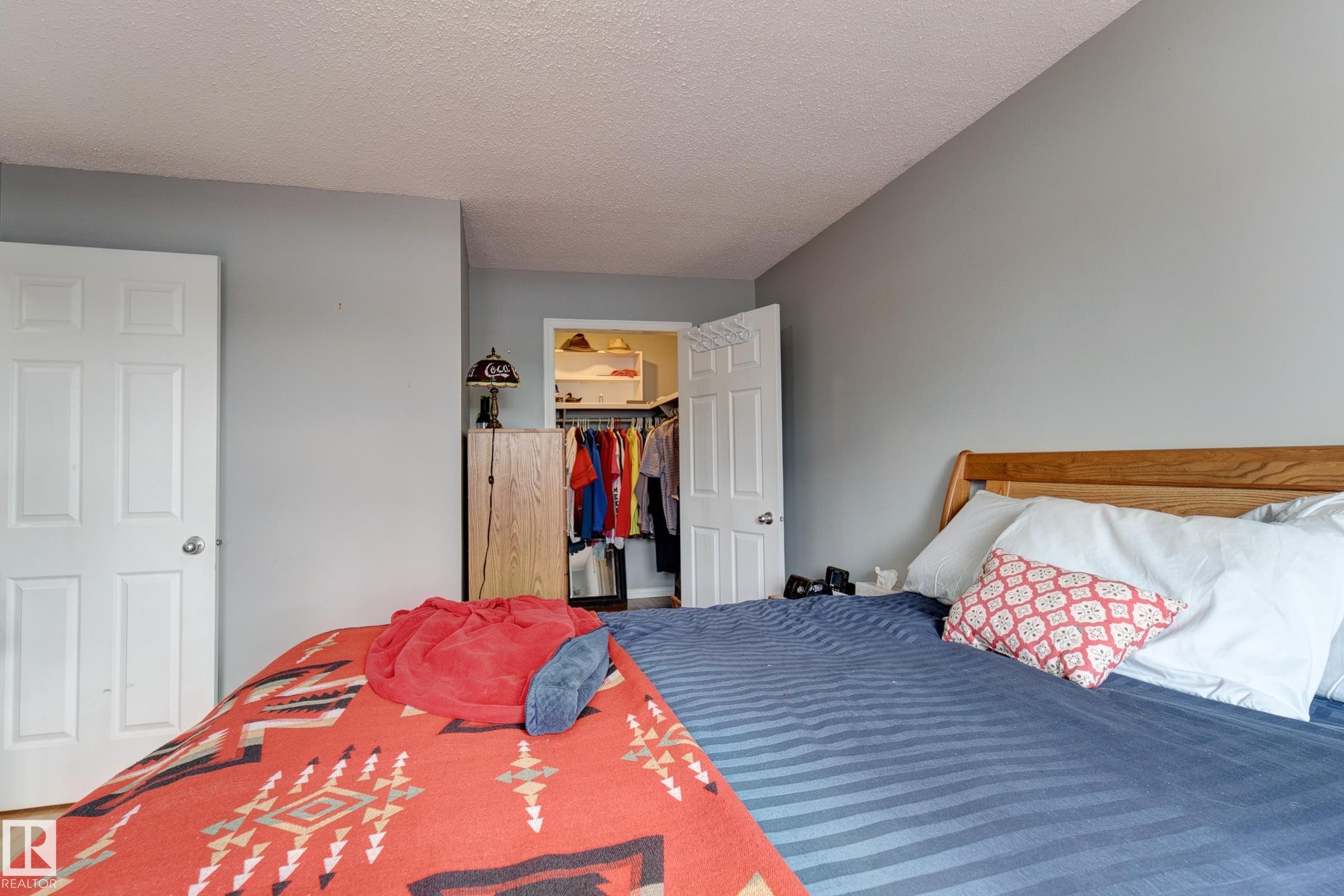 Bedroom featuring a spacious closet and a textured ceiling - 4823 10 Avenue, Edmonton, AB - Indoor Photo Showing Bedroom