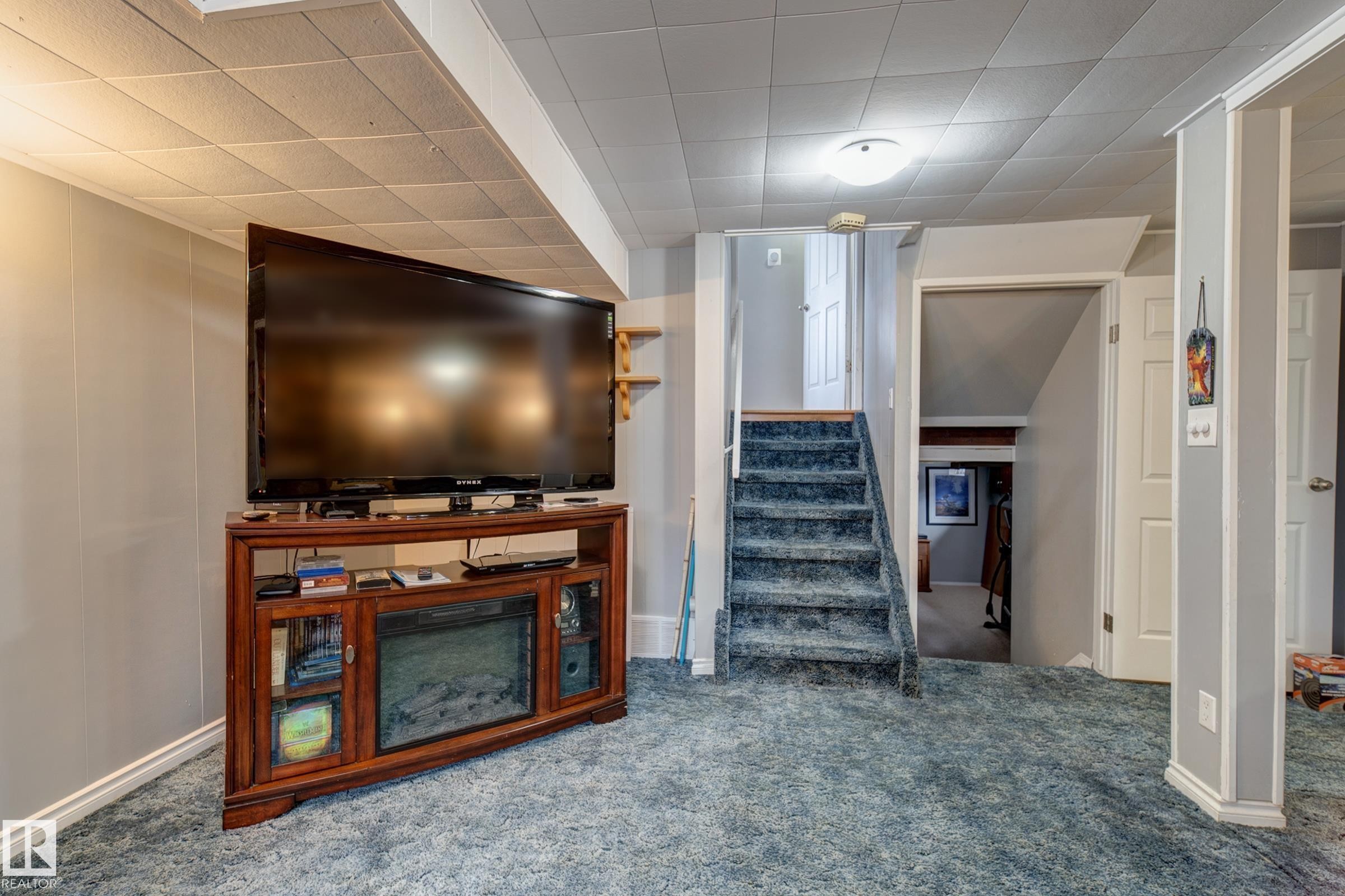 Living room featuring carpet floors and stairs - 4823 10 Avenue, Edmonton, AB - Indoor