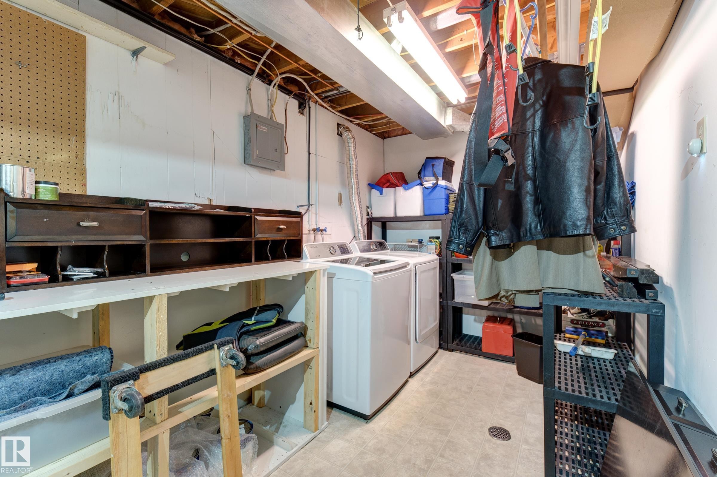 Laundry area featuring washing machine and dryer, electric panel, and light floors - 4823 10 Avenue, Edmonton, AB - Indoor Photo Showing Laundry Room