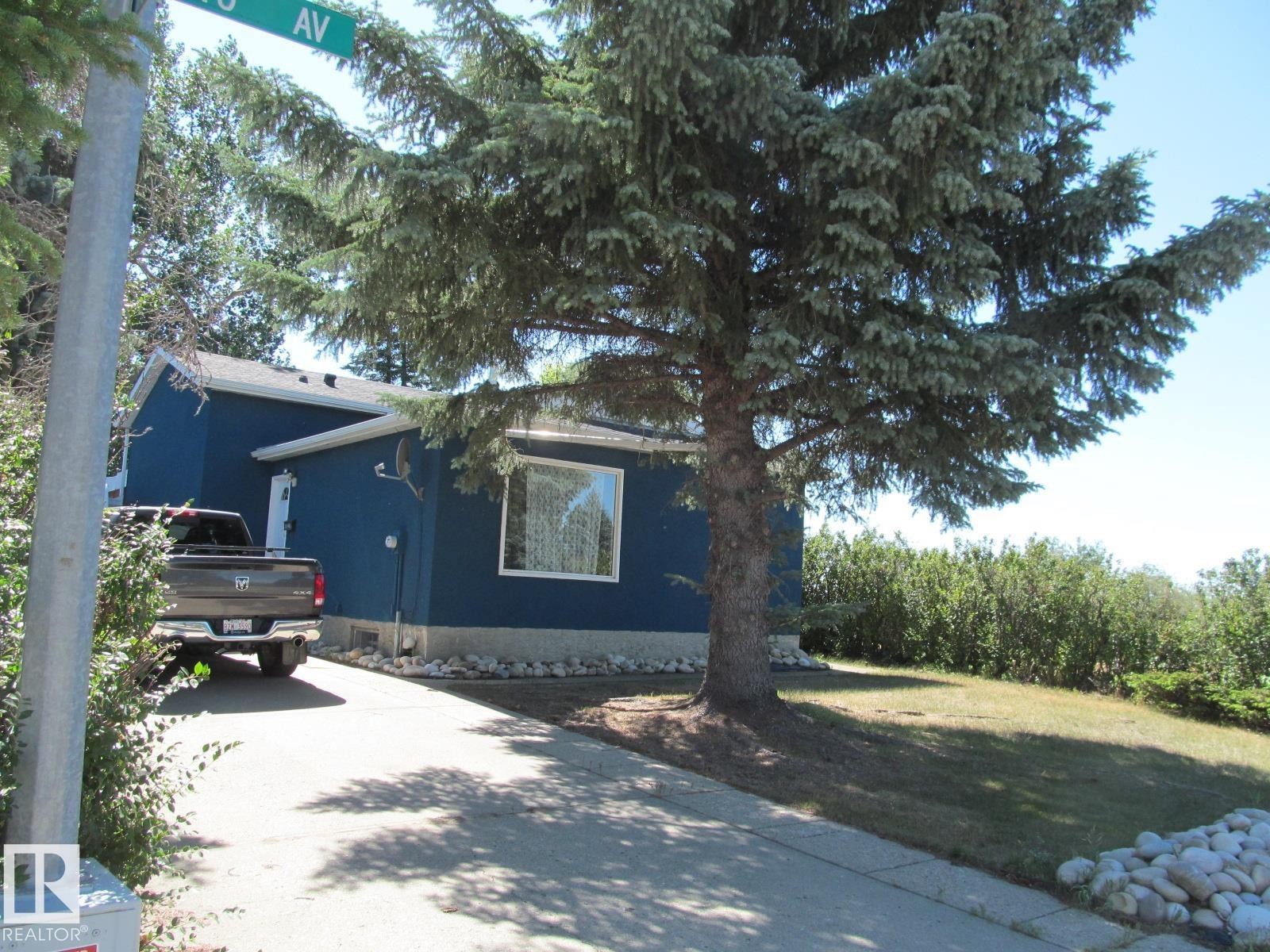 View of home's exterior with concrete driveway and a yard - 4823 10 Avenue, Edmonton, AB - Outdoor
