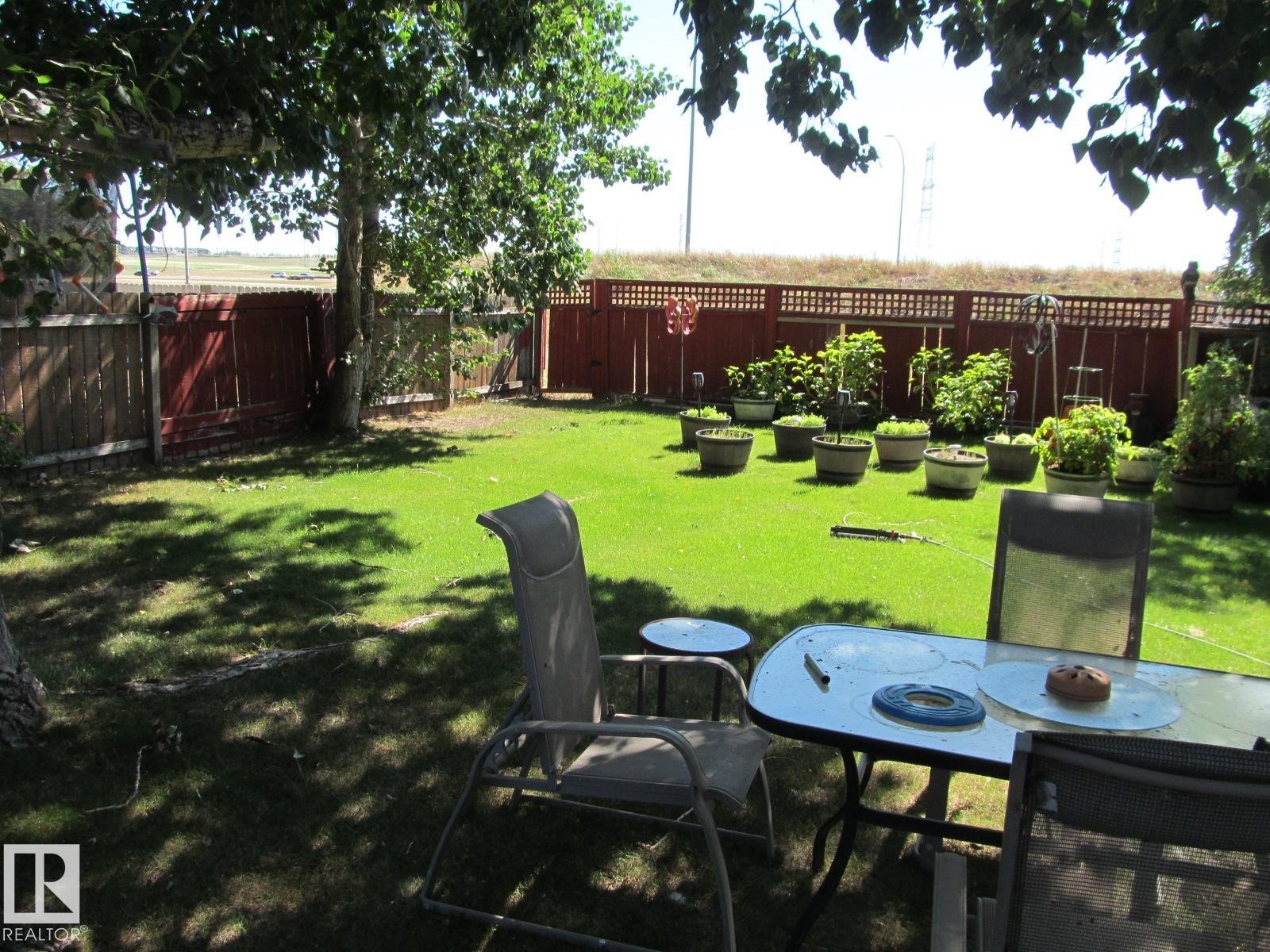 Fenced backyard with outdoor dining space - 4823 10 Avenue, Edmonton, AB - Outdoor With Backyard