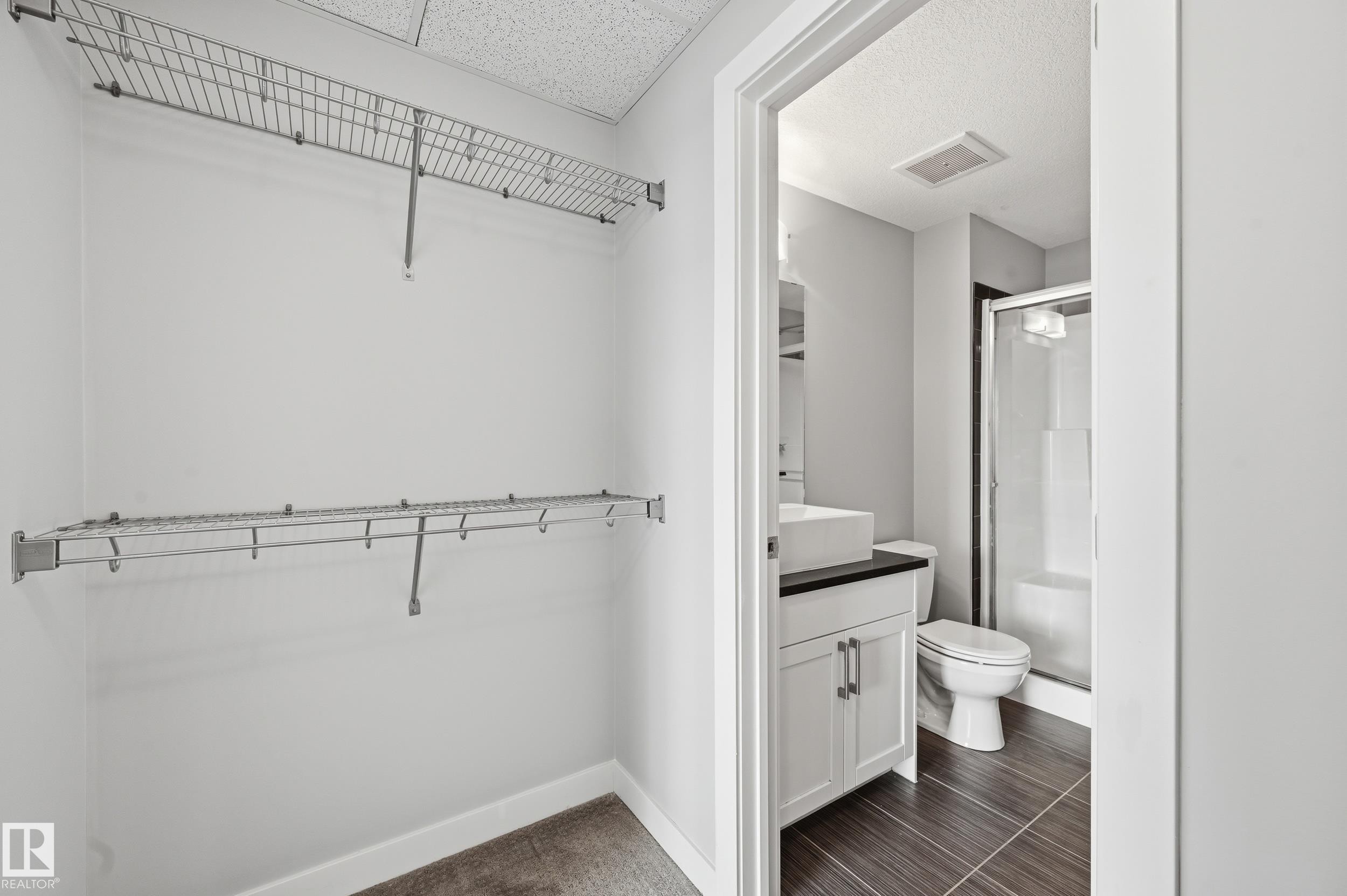 Walk in closet featuring a sink - 511 5151 Windermere Boulevard, Edmonton, AB - Indoor With Storage