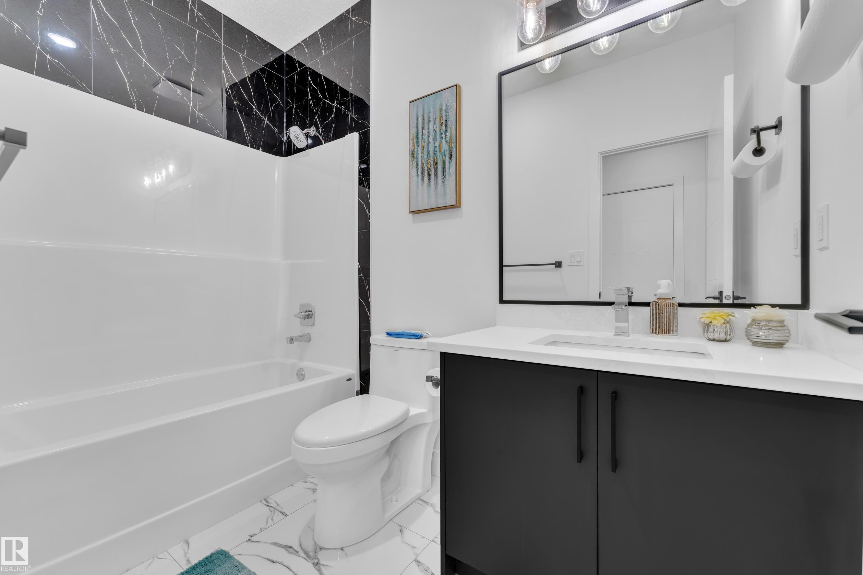 Full bath with vanity, bathtub / shower combination, and light marble finish floors - 16812 48 Street Nw, Edmonton, AB - Indoor Photo Showing Bathroom