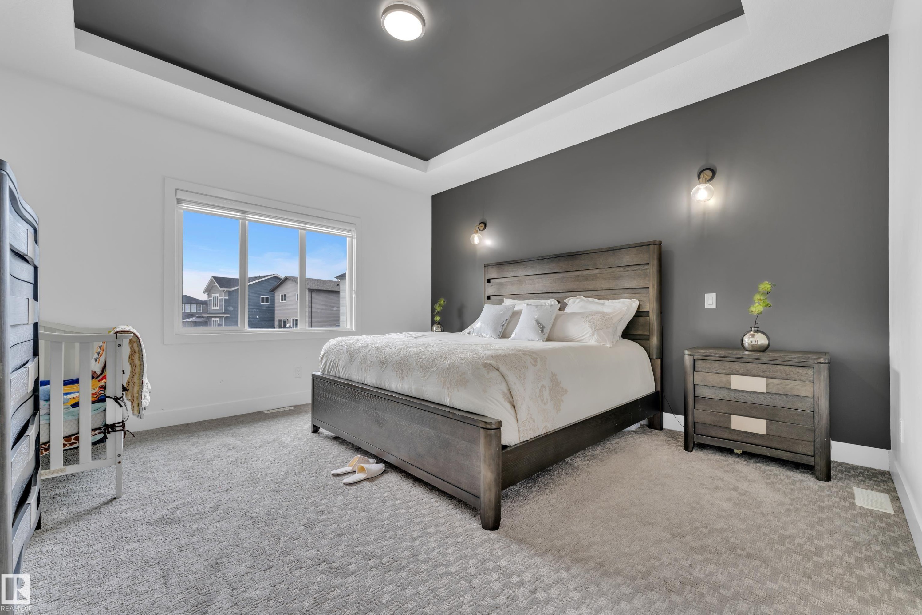 Bedroom with a tray ceiling and light colored carpet - 16812 48 Street Nw, Edmonton, AB - Indoor Photo Showing Bedroom