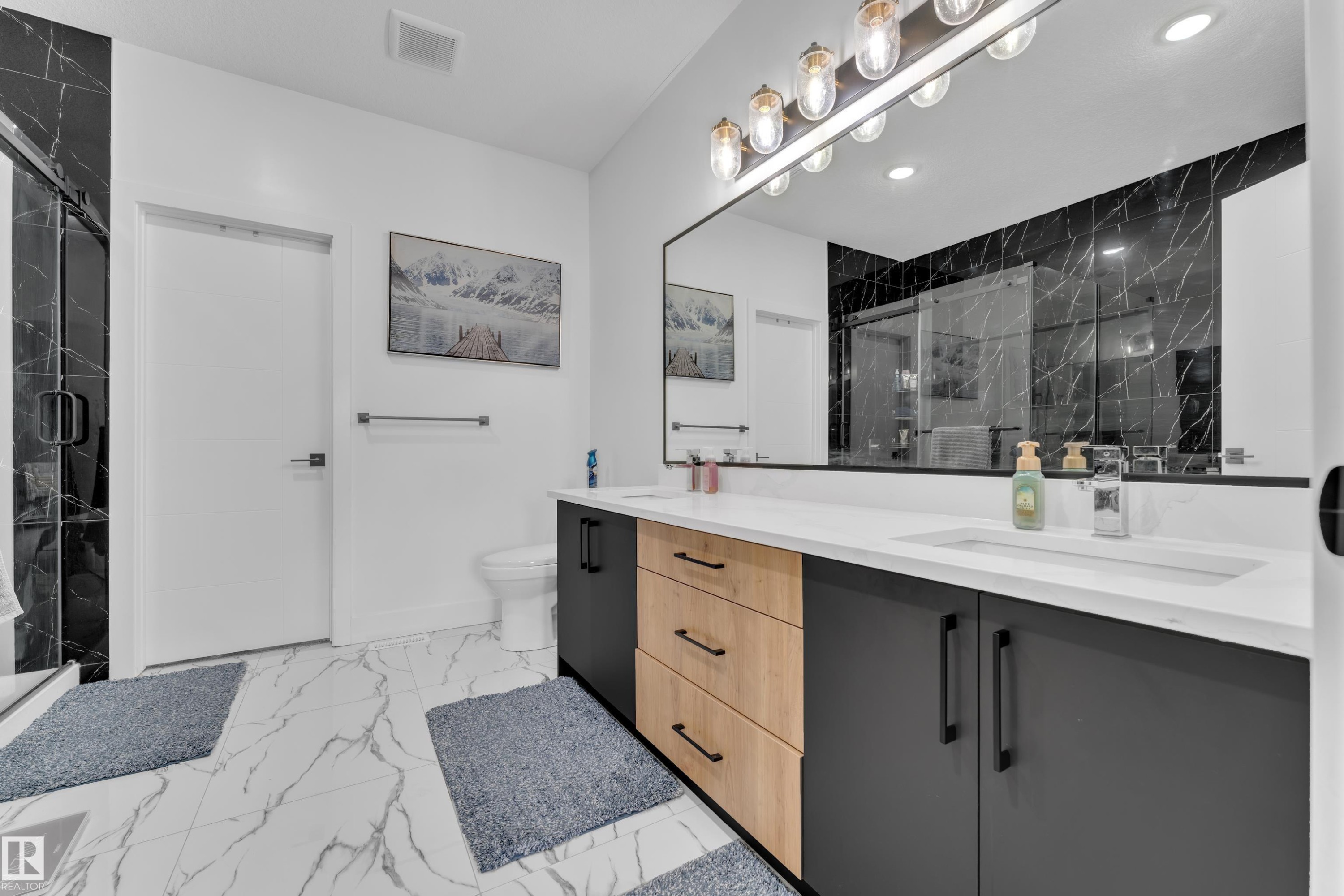 Full bathroom with double vanity, a marble finish shower, light marble finish floors, and recessed lighting - 16812 48 Street Nw, Edmonton, AB - Indoor Photo Showing Bathroom