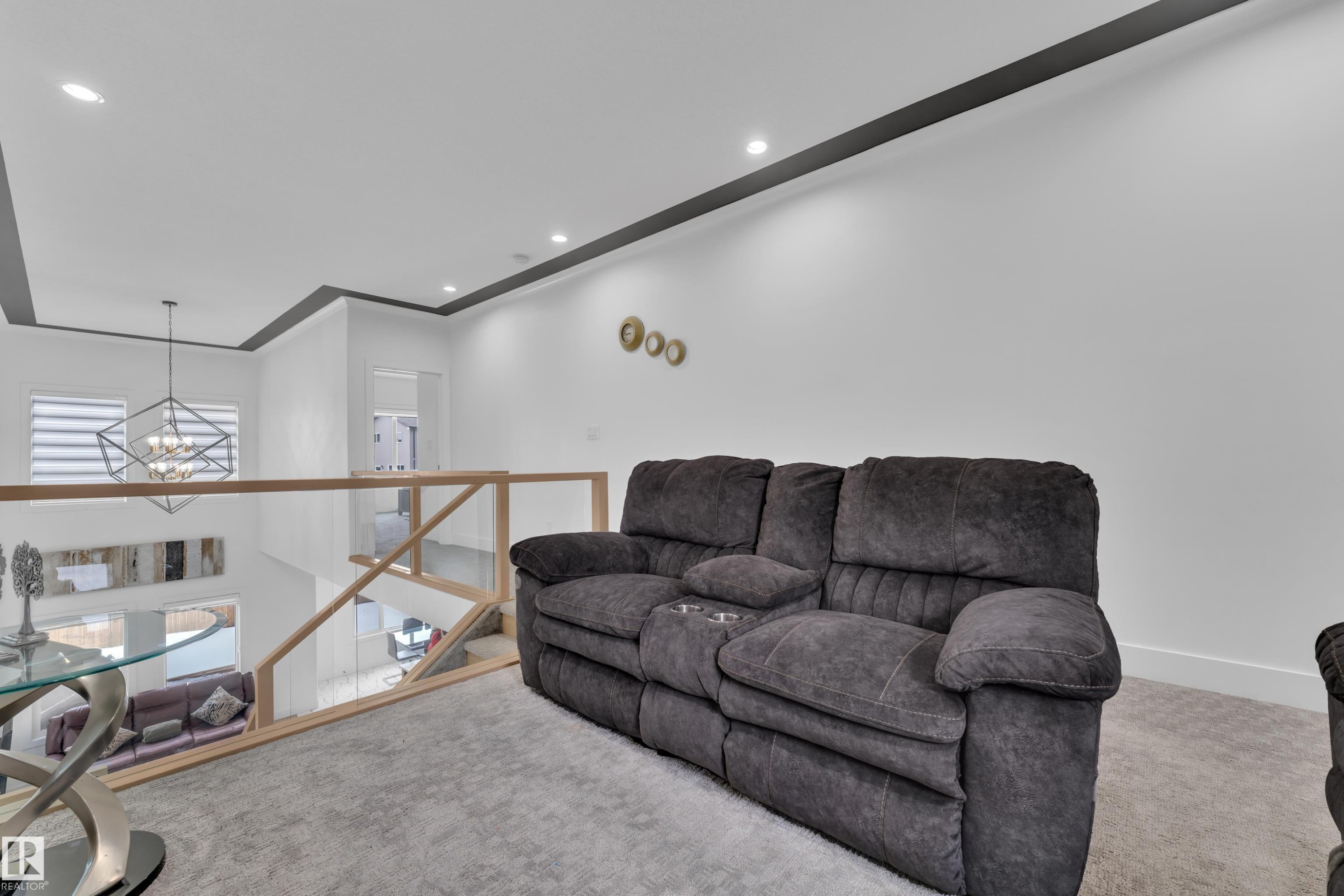 Carpeted living area with a chandelier - 16812 48 Street Nw, Edmonton, AB - Indoor