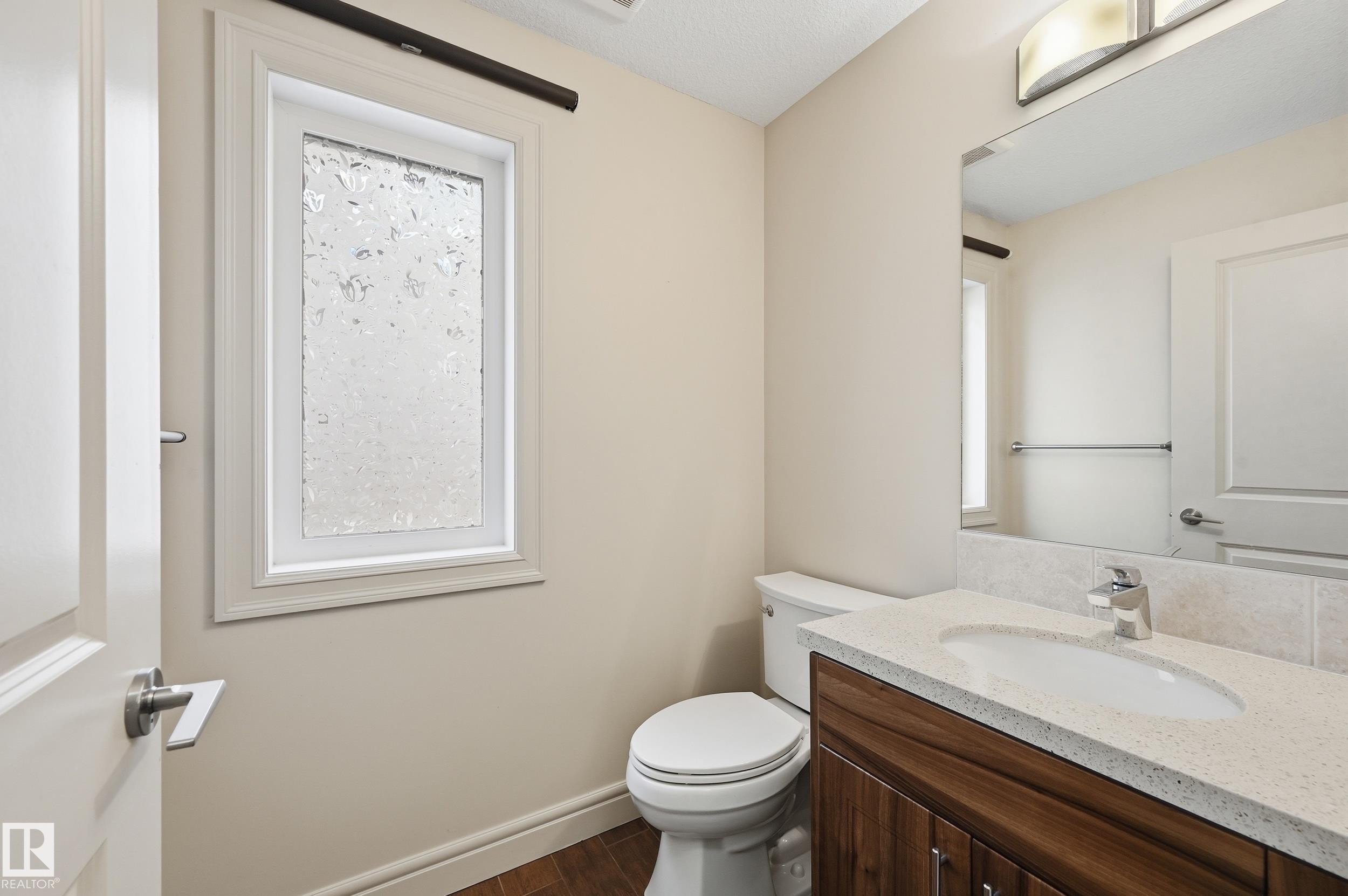 Half bathroom with vanity and dark wood finished floors - 1346 Cunningham Drive W, Edmonton, AB - Indoor Photo Showing Bathroom