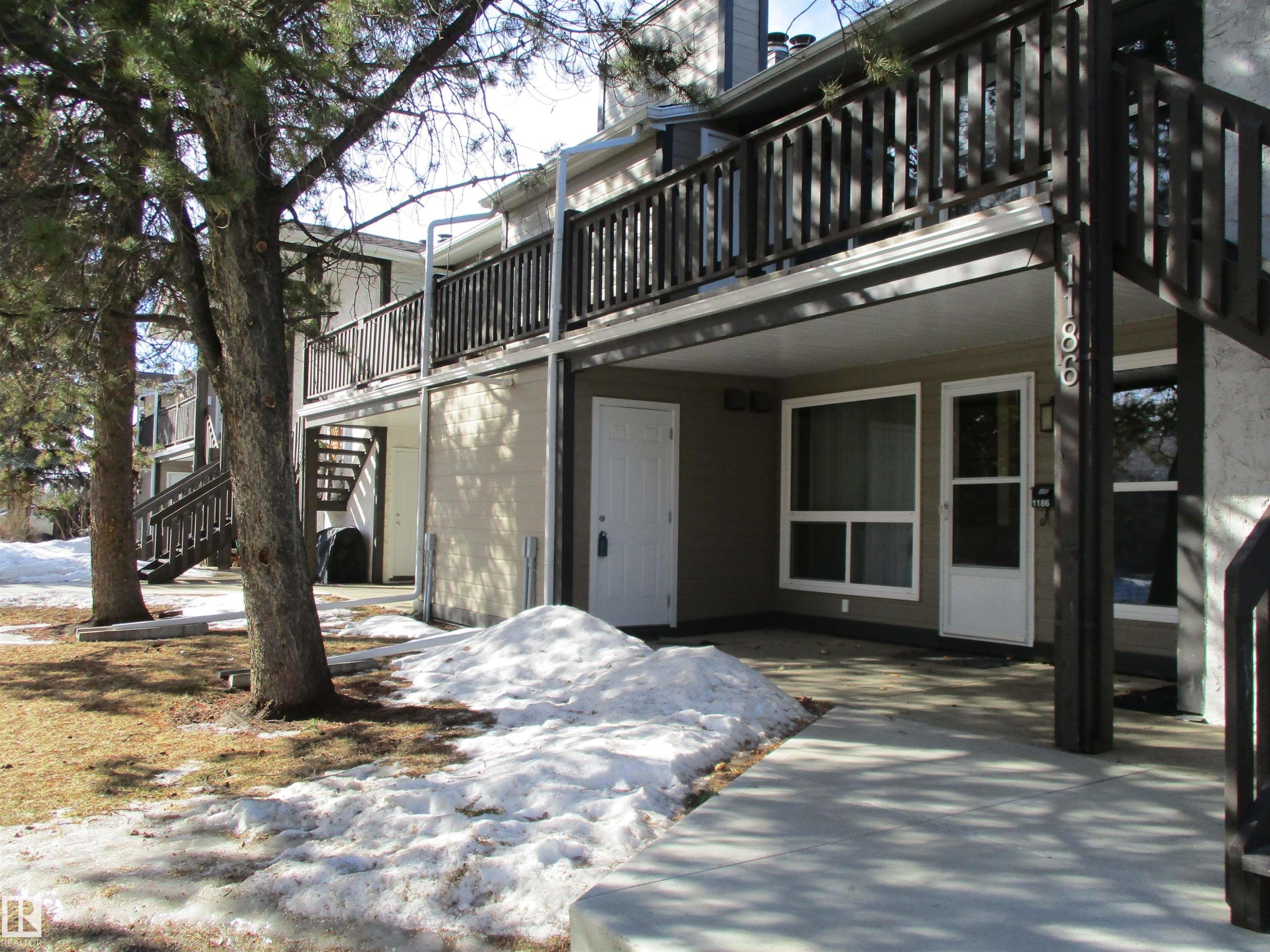 Snow covered property entrance with a deck - 1186 Saddleback Road, Edmonton, AB - Outdoor