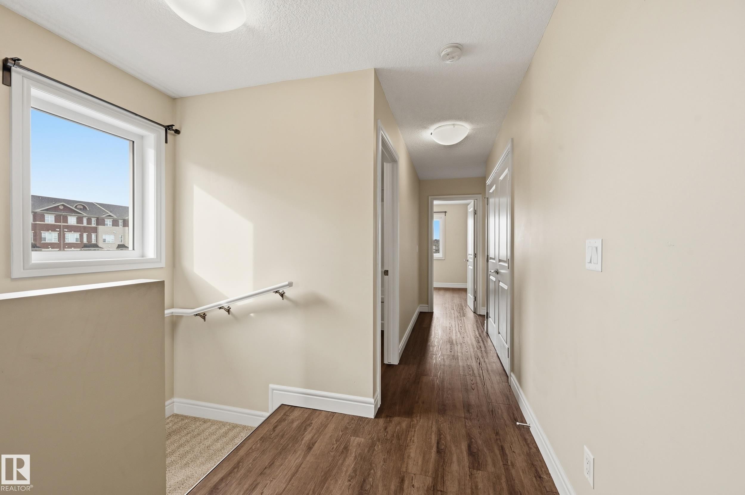 Hall with dark wood-style flooring and a textured ceiling - 1351 Cunningham Drive, Edmonton, AB - Indoor Photo Showing Other Room