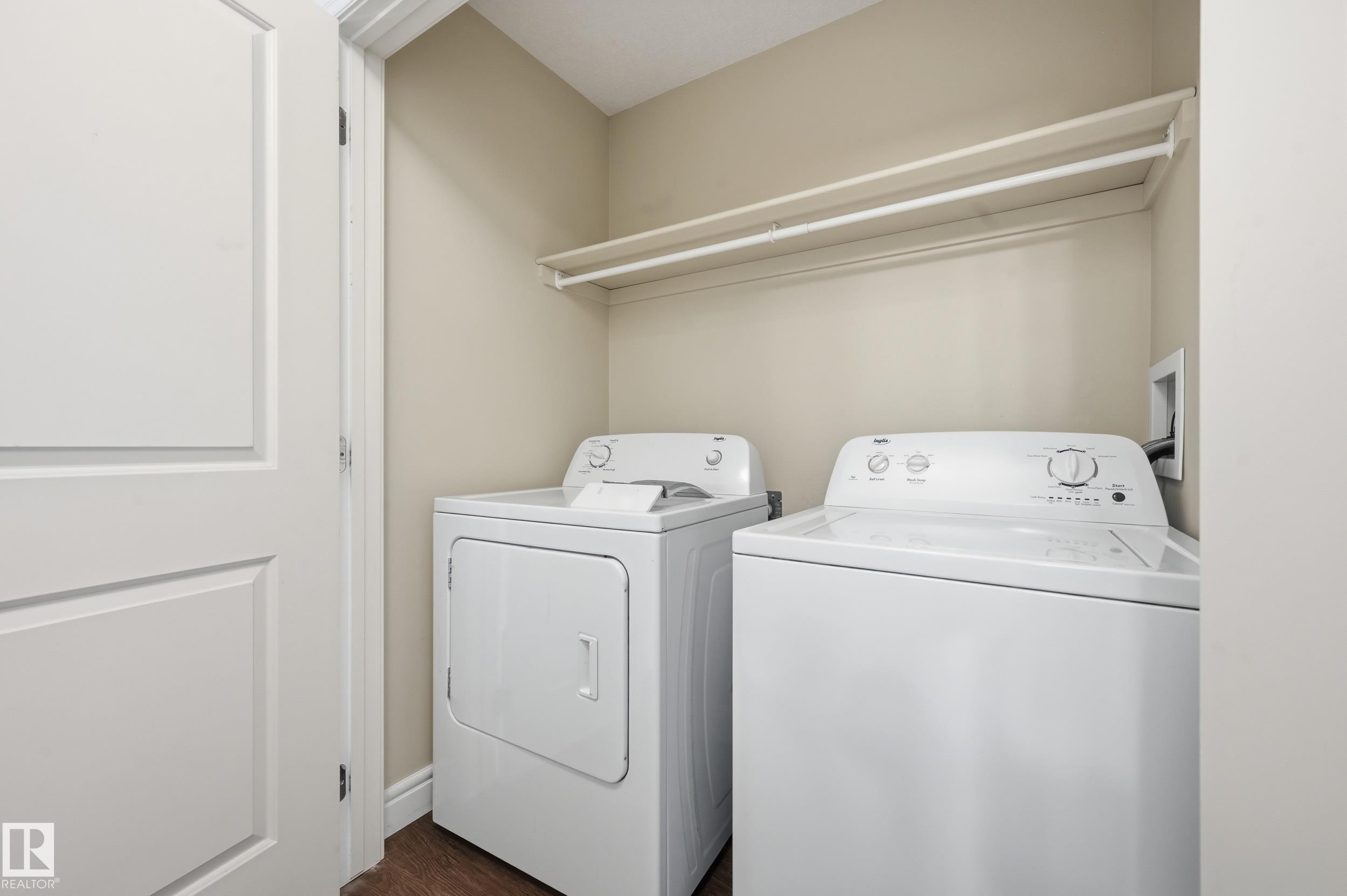 Laundry area featuring independent washer and dryer and dark wood finished floors - 1351 Cunningham Drive, Edmonton, AB - Indoor Photo Showing Laundry Room