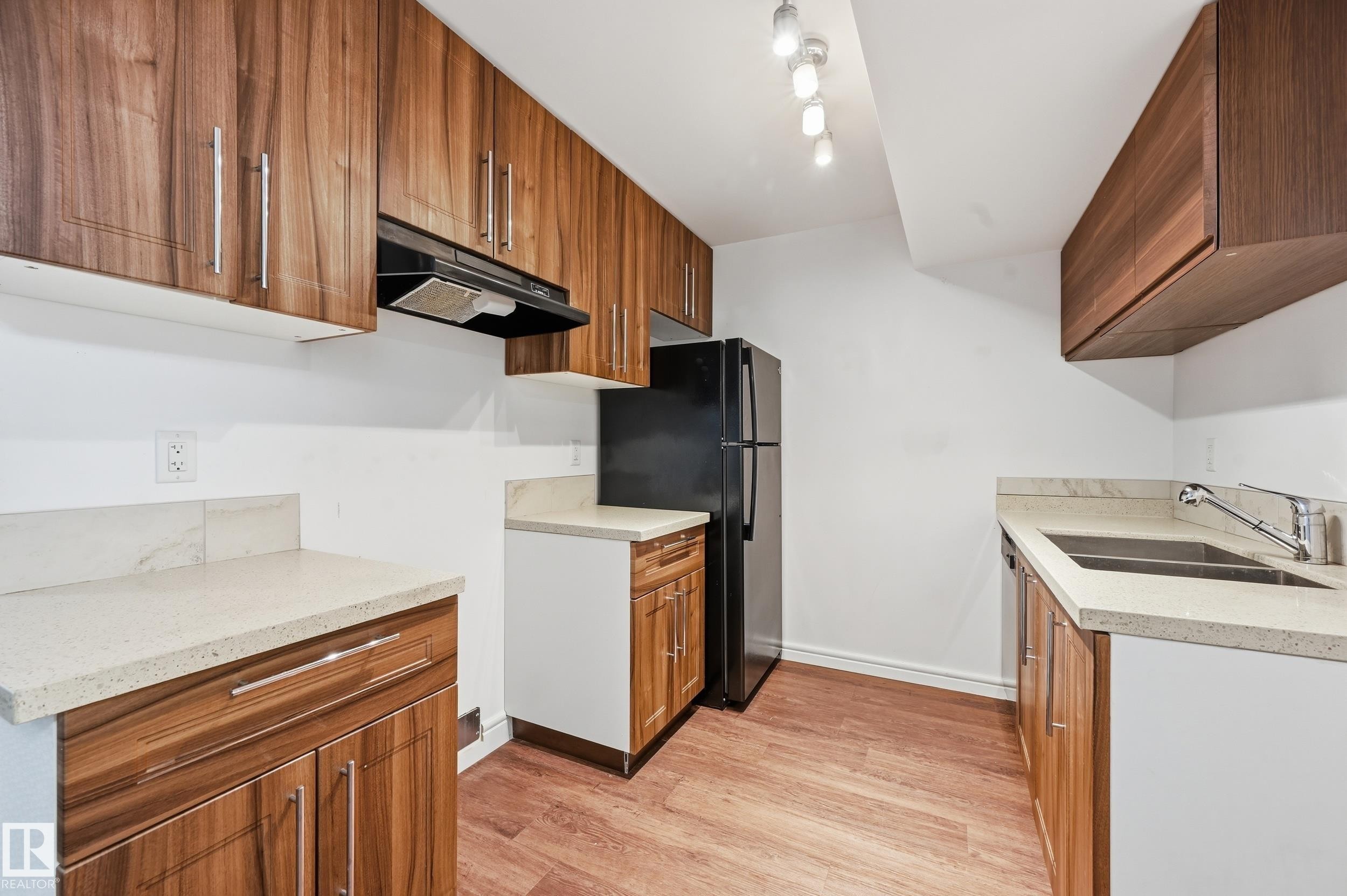 Kitchen featuring light wood finished floors, wood finish cabinets, and freestanding refrigerator - 1351 Cunningham Drive, Edmonton, AB - Indoor Photo Showing Kitchen With Double Sink