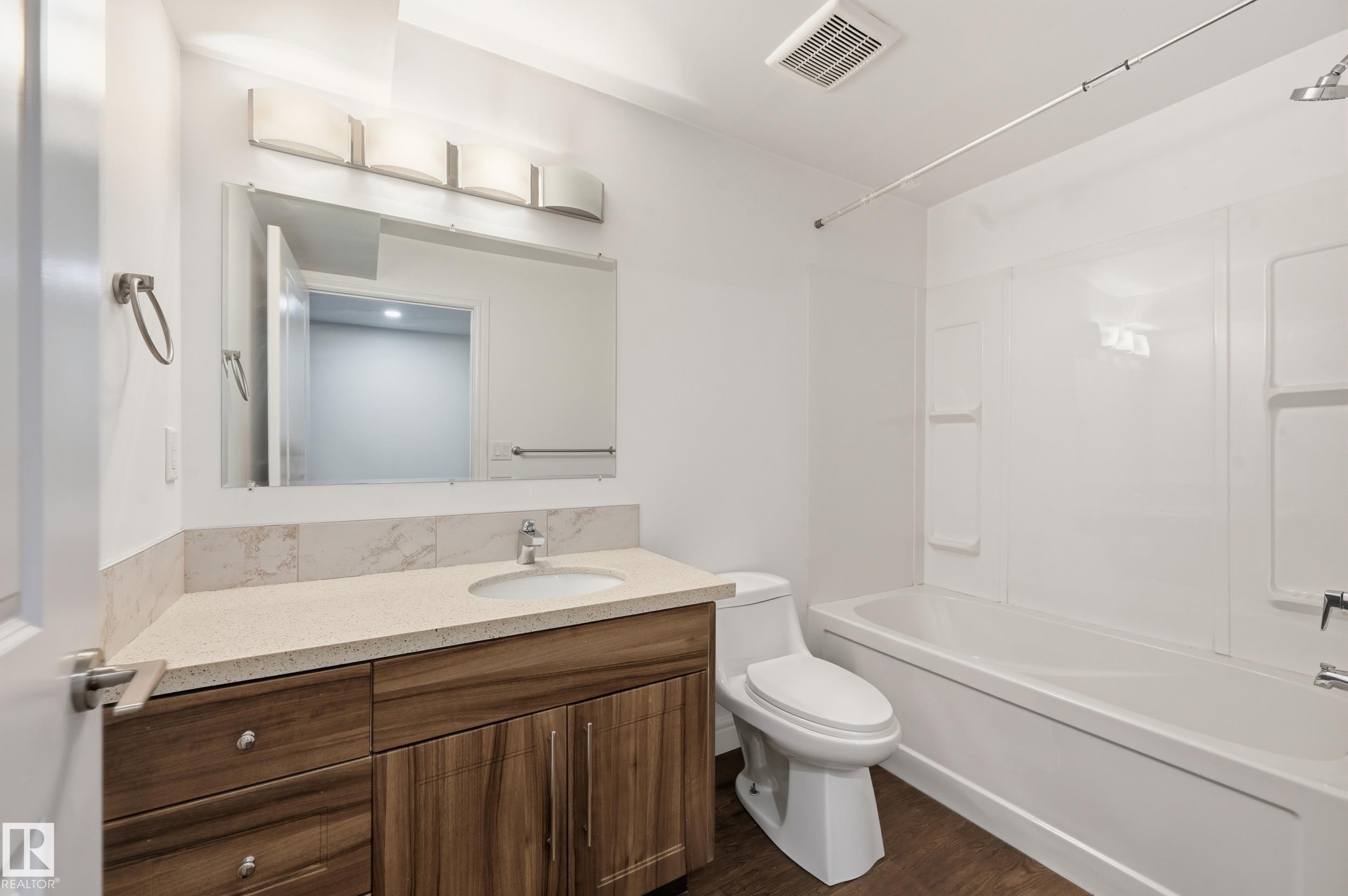 Full bath with vanity, tub / shower combination, and dark wood-style flooring - 1351 Cunningham Drive, Edmonton, AB - Indoor Photo Showing Bathroom