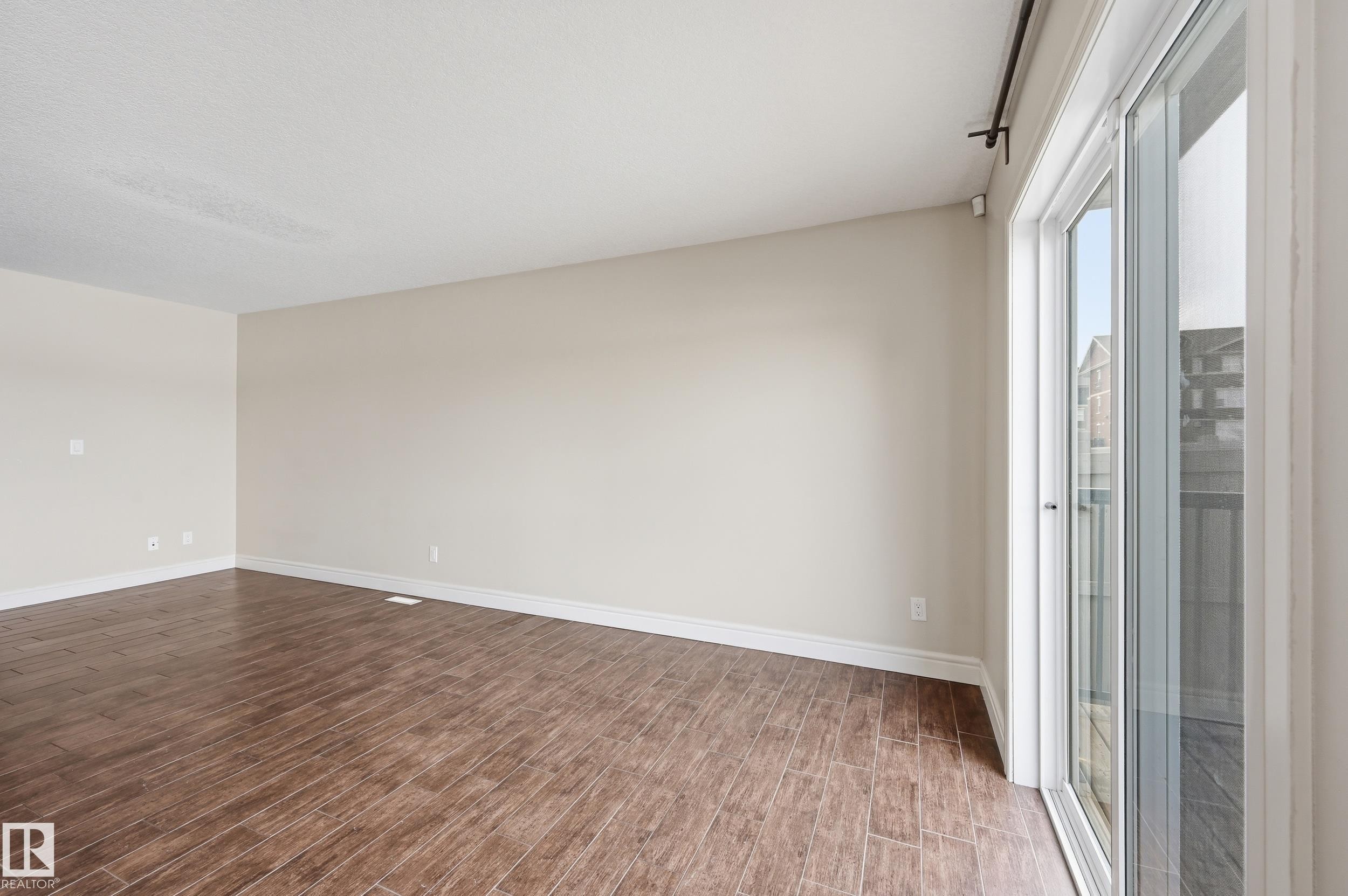 Unfurnished room featuring dark wood-type flooring and baseboards - 1351 Cunningham Drive, Edmonton, AB - Indoor Photo Showing Other Room