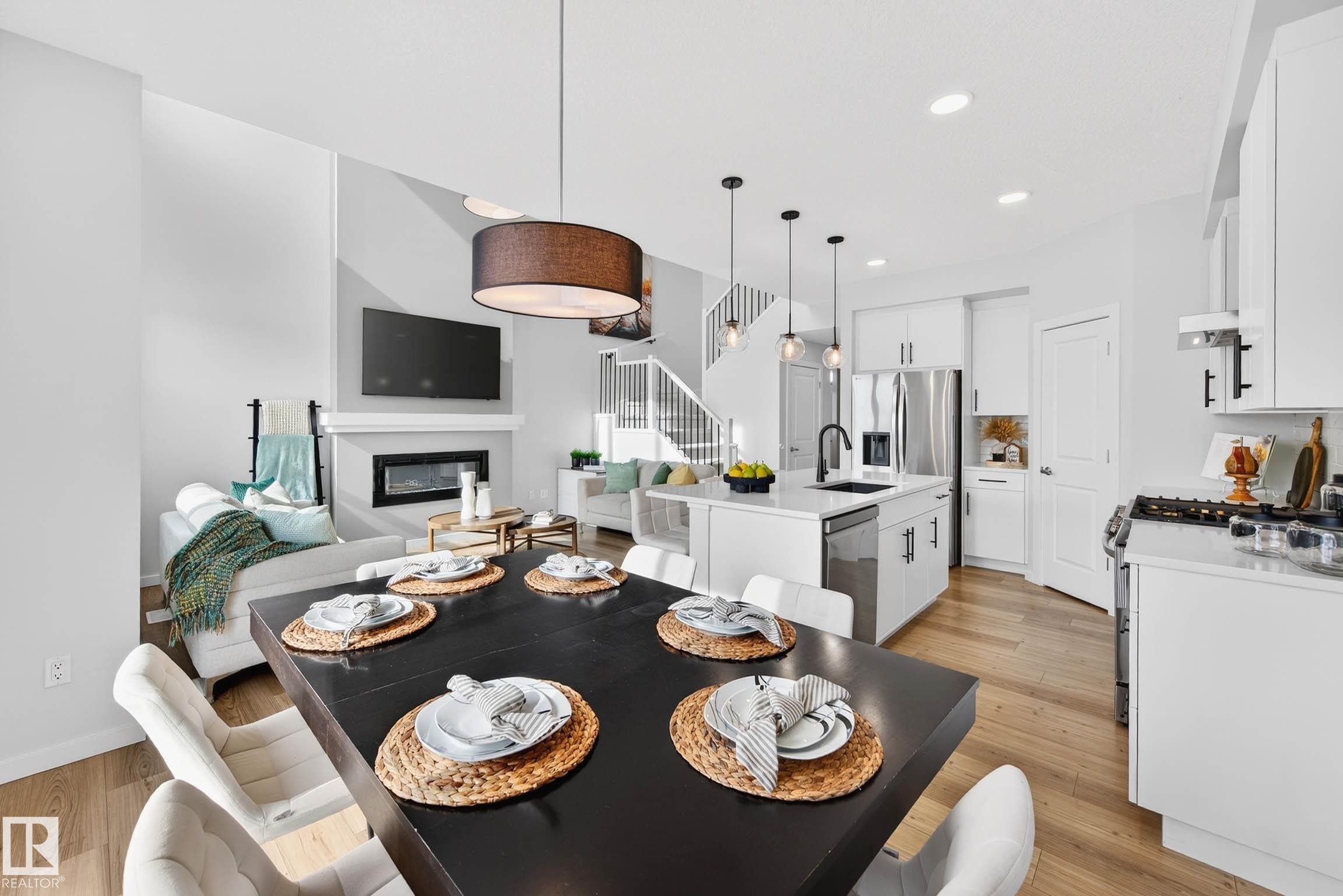 324 Stiles Way, Leduc, AB - Indoor Photo Showing Dining Room With Fireplace
