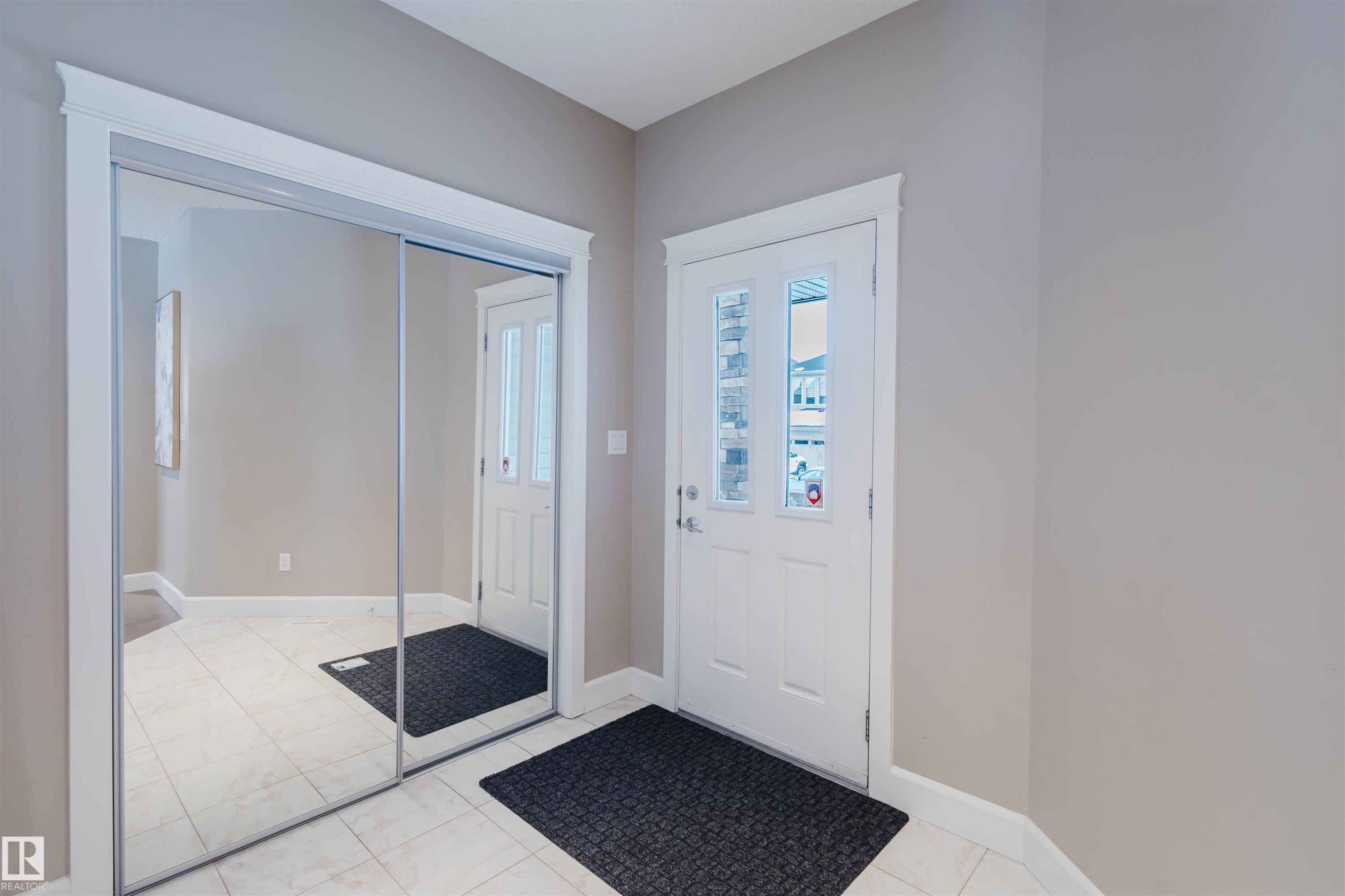 Entrance foyer featuring baseboards and light tile patterned flooring - 1957 Ainslie Link, Edmonton, AB - Indoor Photo Showing Other Room