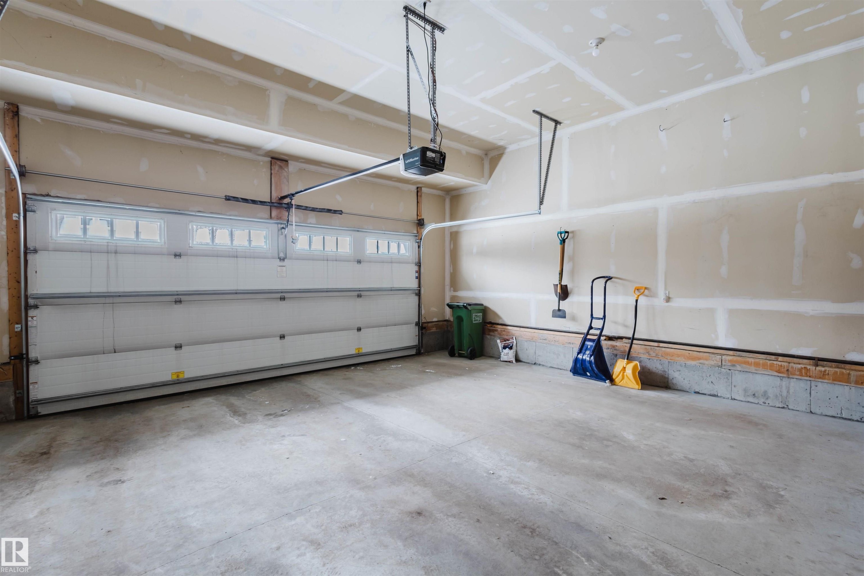 Garage featuring a garage door opener - 1957 Ainslie Link, Edmonton, AB - Indoor Photo Showing Garage