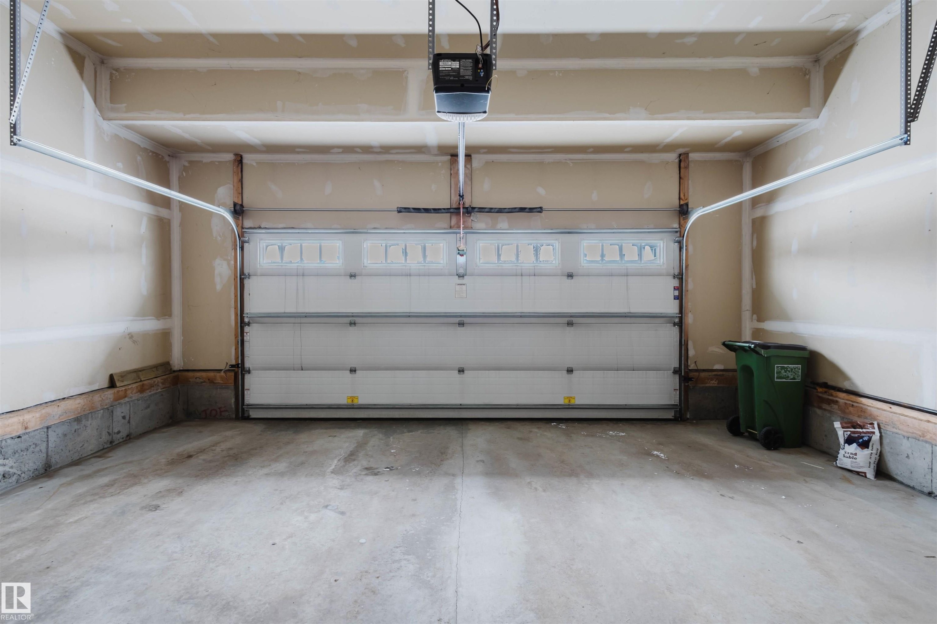 Garage featuring a garage door opener - 1957 Ainslie Link, Edmonton, AB - Indoor Photo Showing Garage