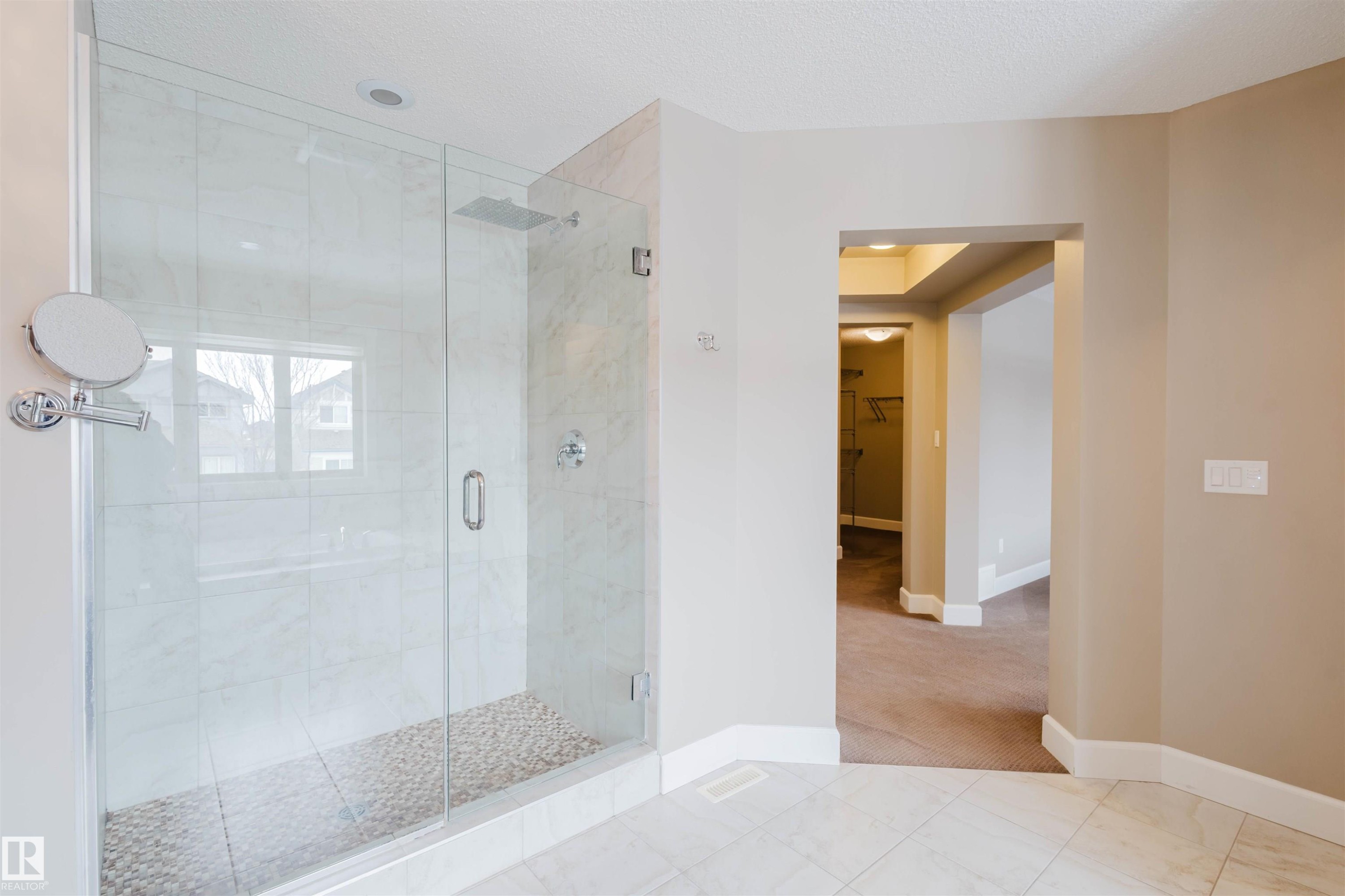 Bathroom with a shower stall, a spacious closet, light carpet, and light tile patterned floors - 1957 Ainslie Link, Edmonton, AB - Indoor Photo Showing Bathroom