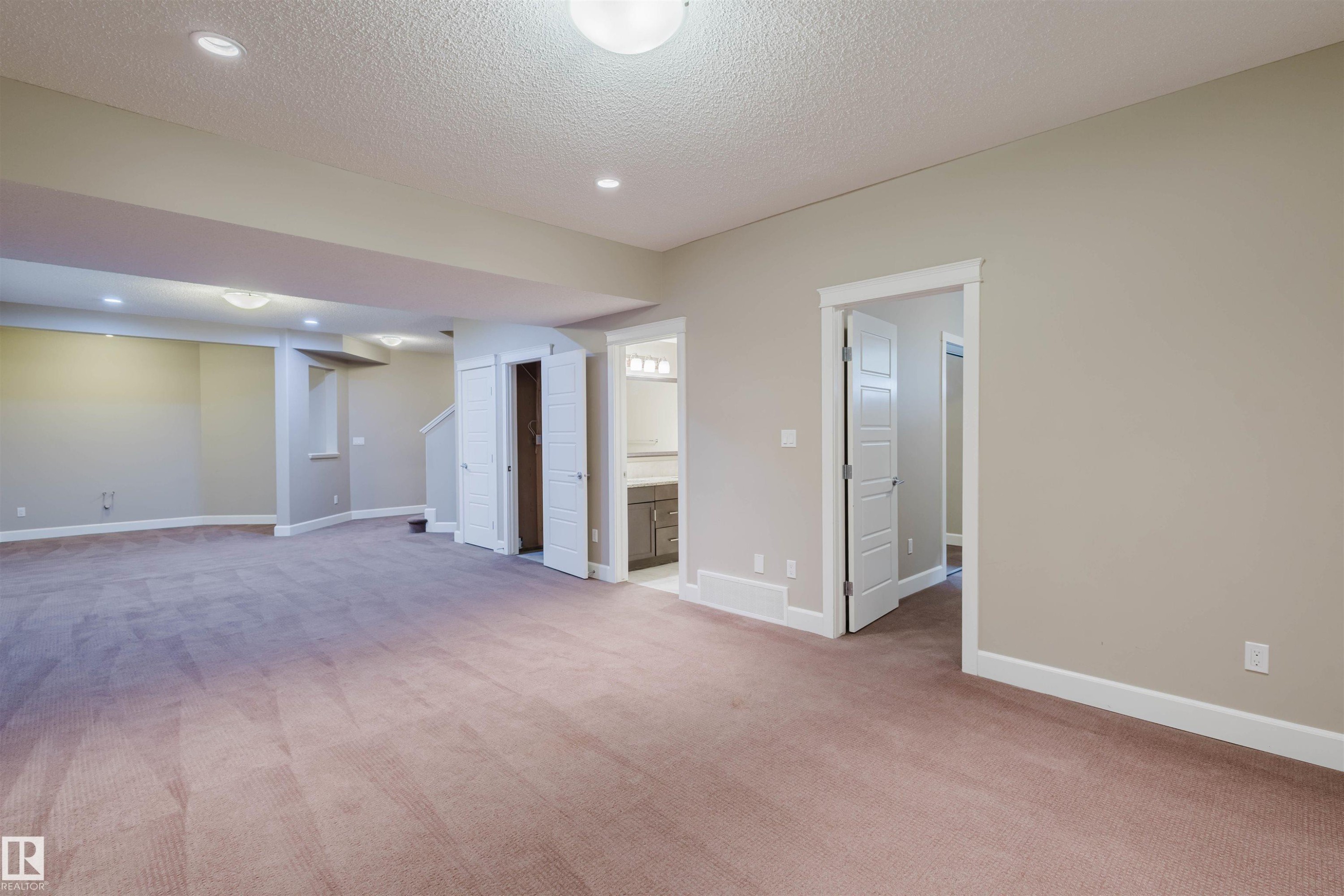 Finished basement featuring light colored carpet, recessed lighting, and a textured ceiling - 1957 Ainslie Link, Edmonton, AB - Indoor Photo Showing Other Room