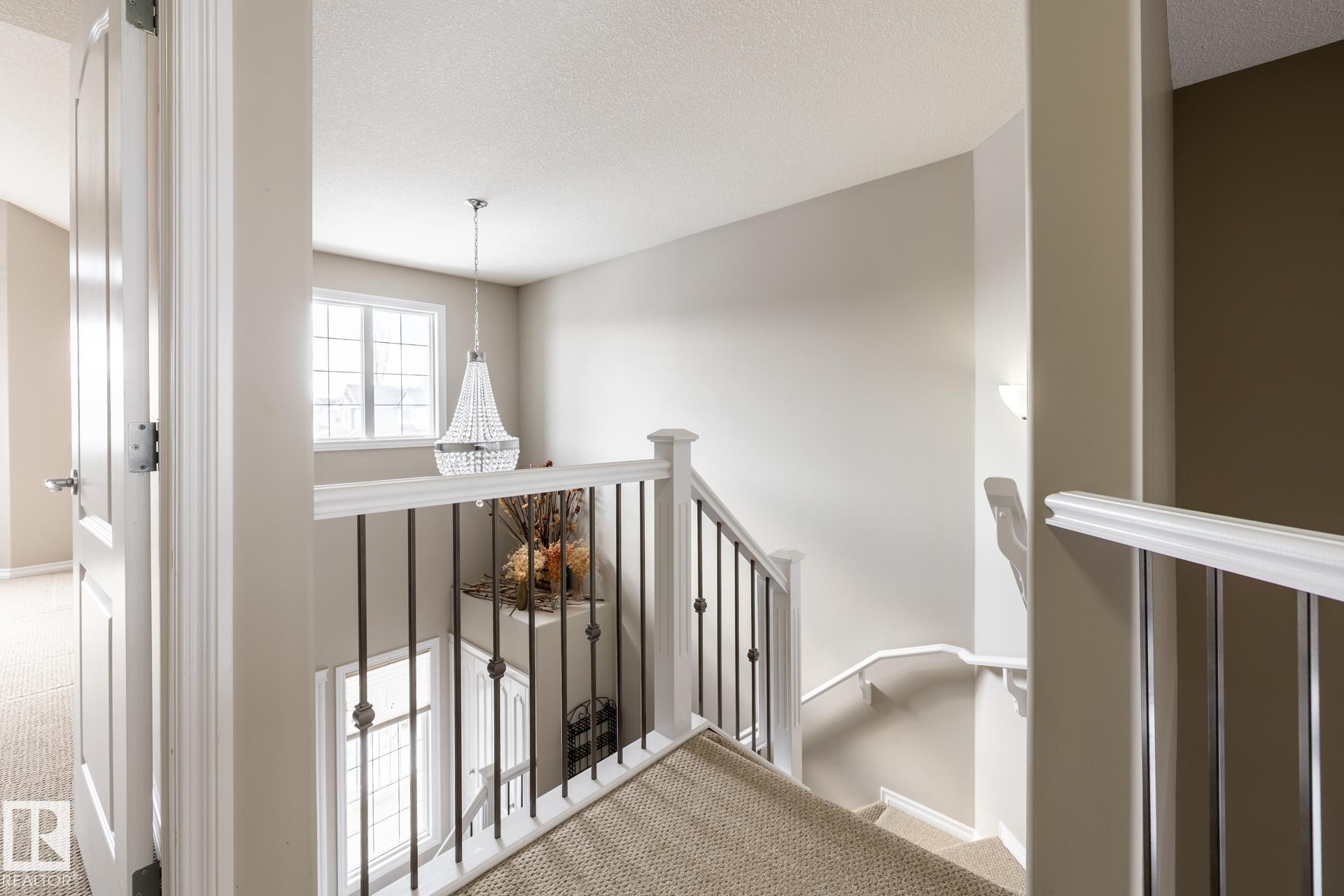 Stairs with carpet flooring and a textured ceiling - 11622 11 Avenue, Edmonton, AB - Indoor Photo Showing Other Room