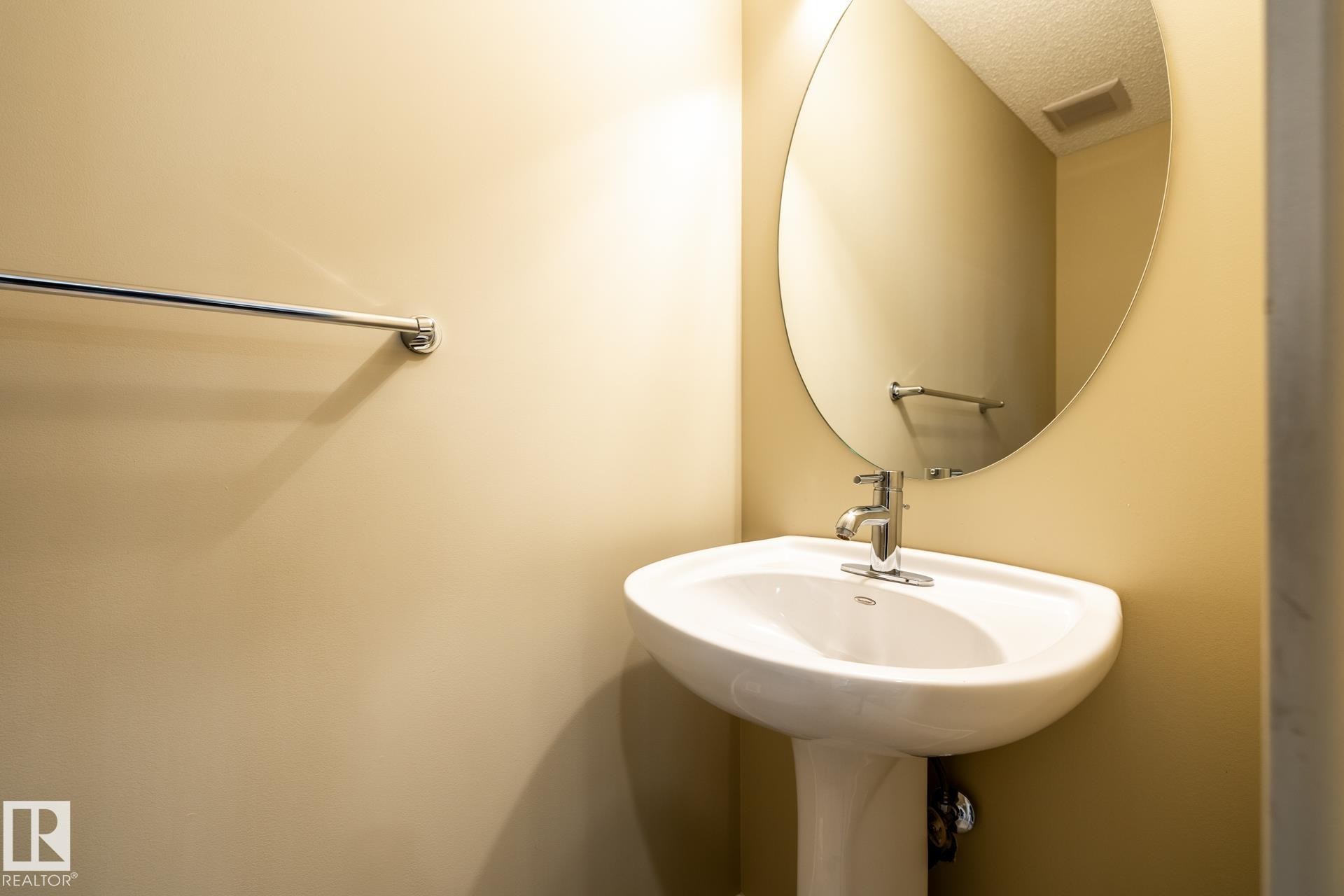 Bathroom with a textured ceiling and a sink - 21 655 Watt Boulevard, Edmonton, AB - Indoor Photo Showing Bathroom