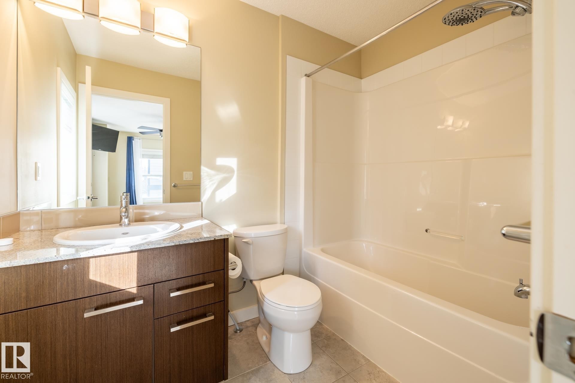 Full bathroom with vanity, light tile patterned flooring, and shower / bathtub combination - 21 655 Watt Boulevard, Edmonton, AB - Indoor Photo Showing Bathroom