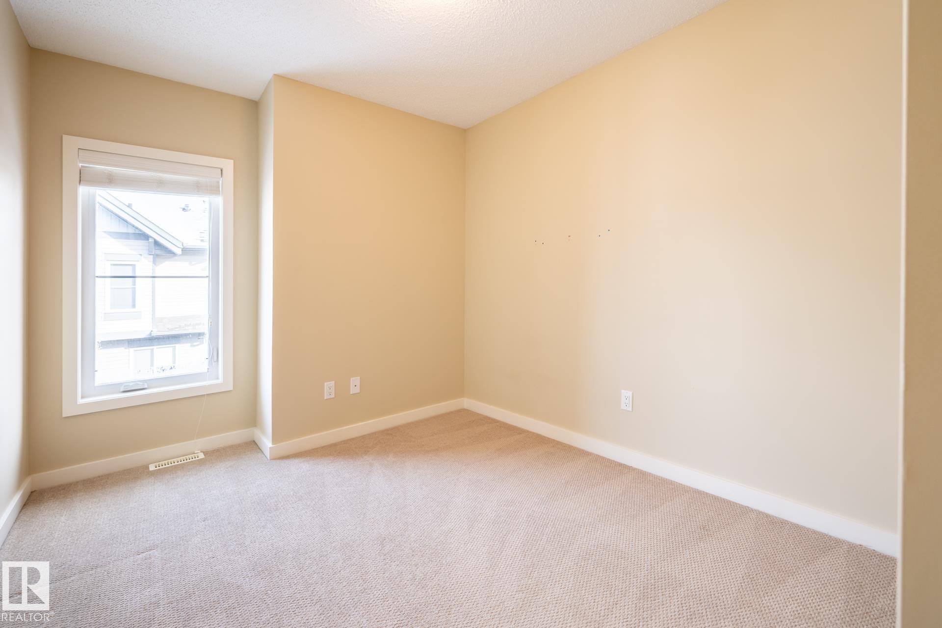 Empty room featuring light colored carpet and baseboards - 21 655 Watt Boulevard, Edmonton, AB - Indoor Photo Showing Other Room