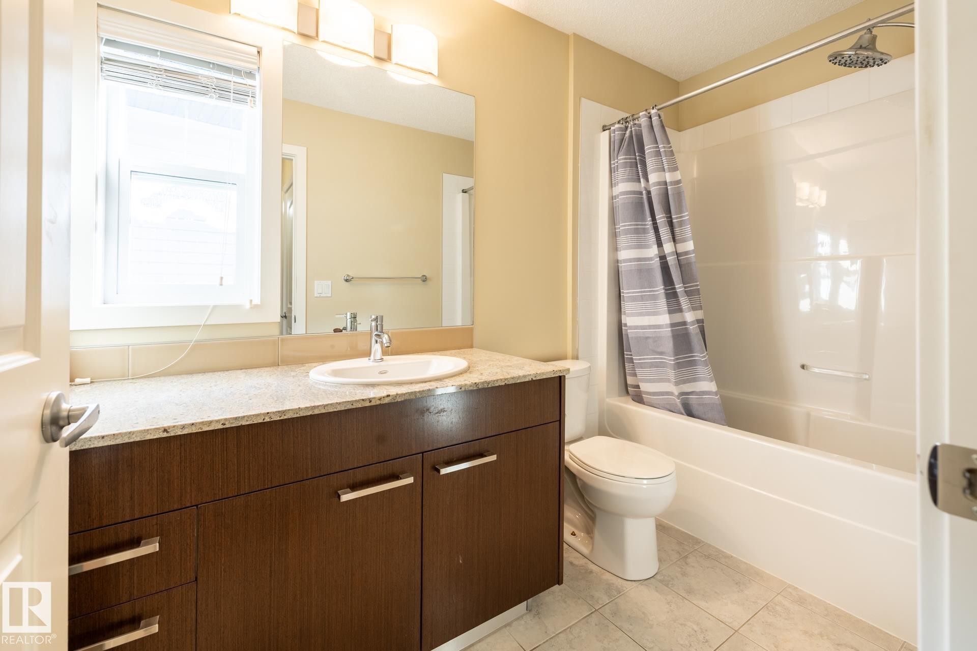 Bathroom featuring vanity and shower / tub combo - 21 655 Watt Boulevard, Edmonton, AB - Indoor Photo Showing Bathroom