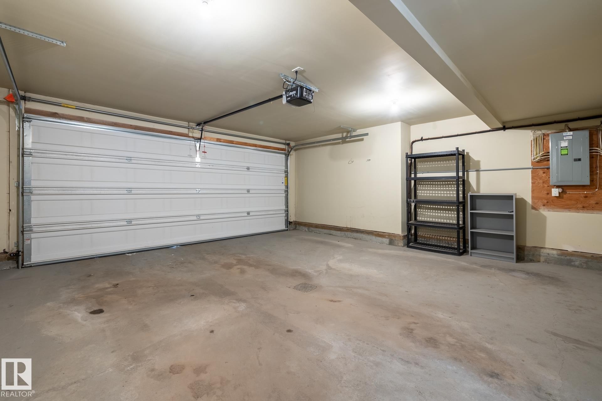 Garage with electric panel and a garage door opener - 21 655 Watt Boulevard, Edmonton, AB - Indoor Photo Showing Garage