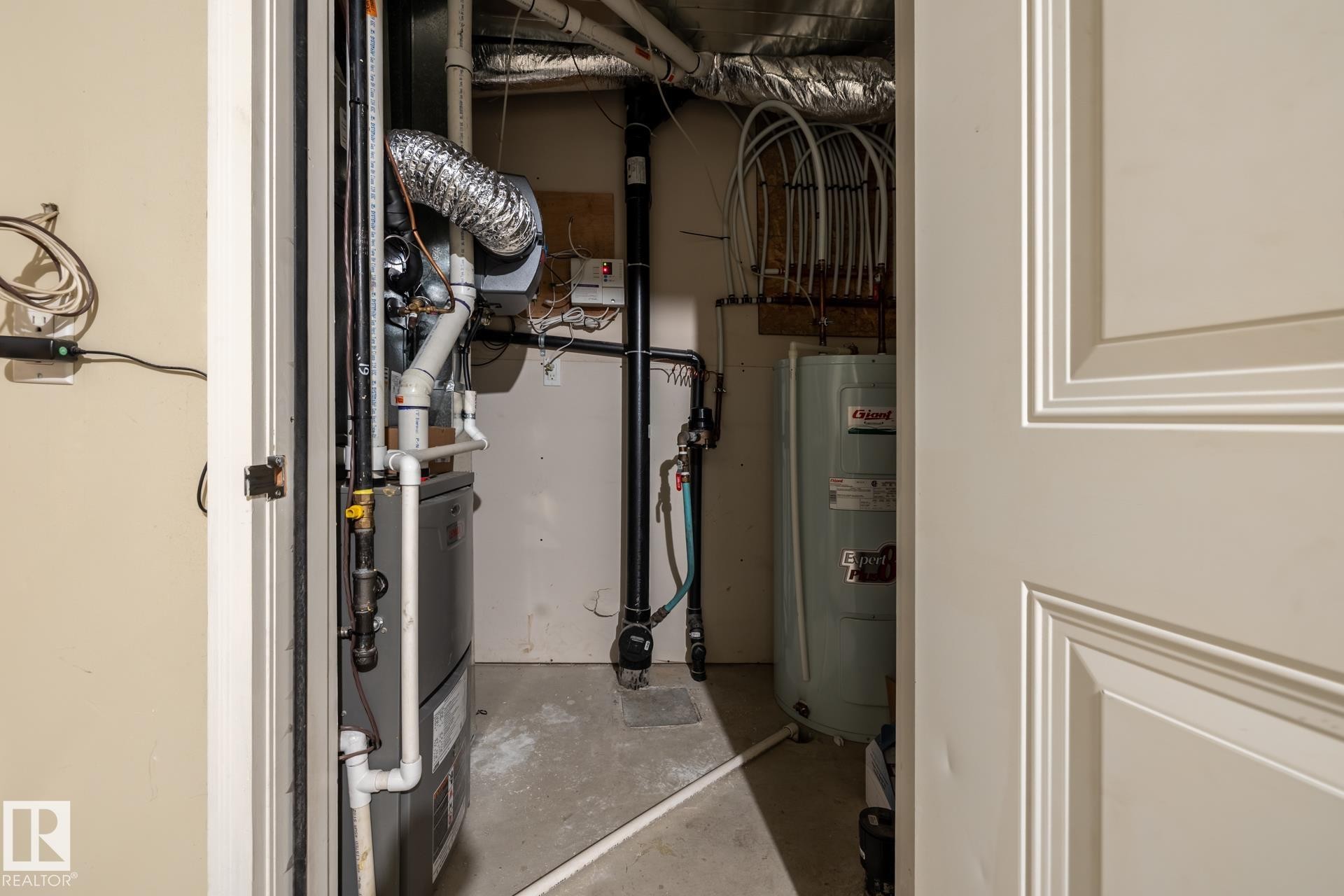 Utility room with water heater and heating unit - 21 655 Watt Boulevard, Edmonton, AB - Indoor Photo Showing Basement
