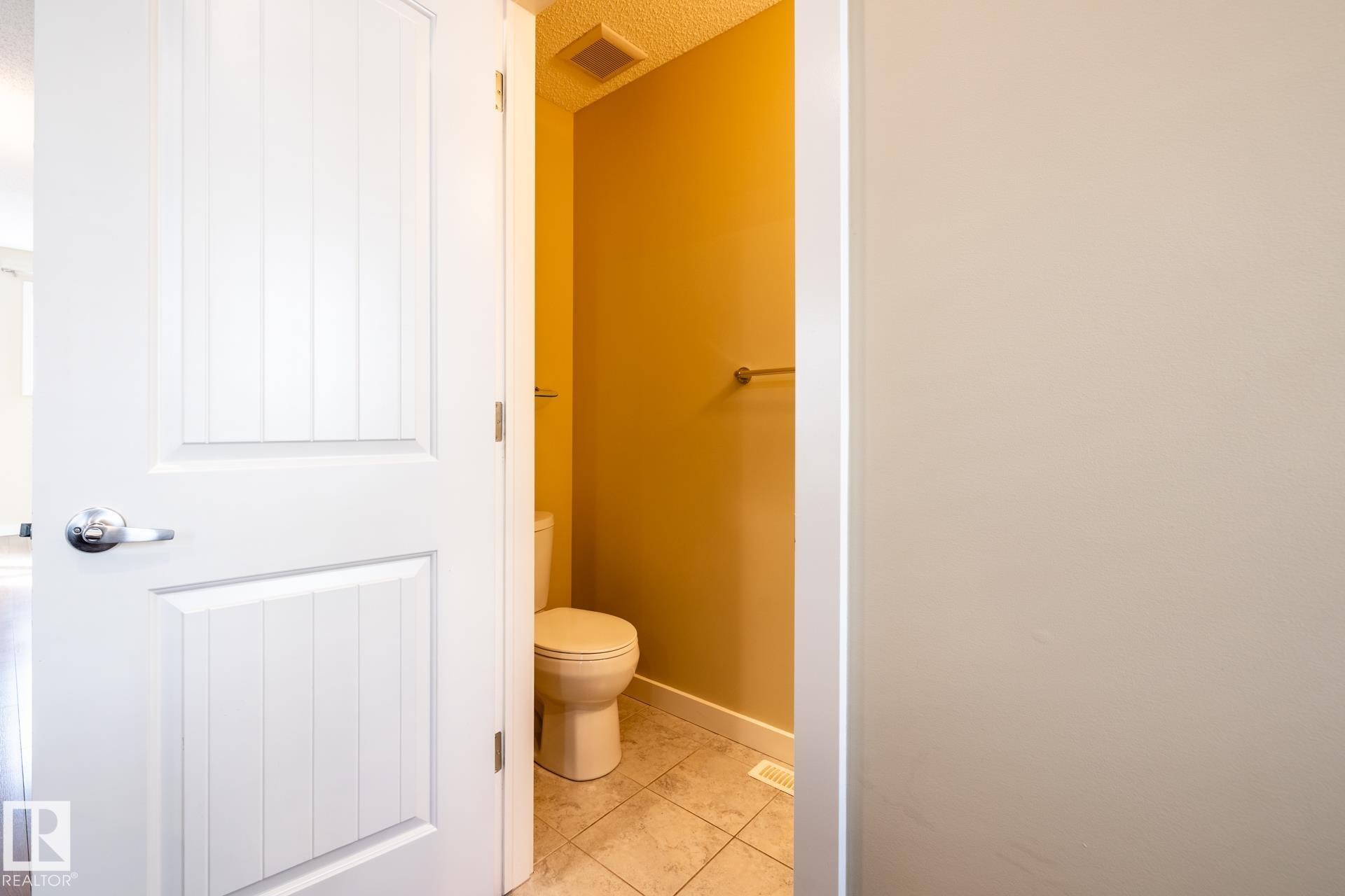 Bathroom with toilet and light tile patterned floors - 21 655 Watt Boulevard, Edmonton, AB - Indoor Photo Showing Bathroom