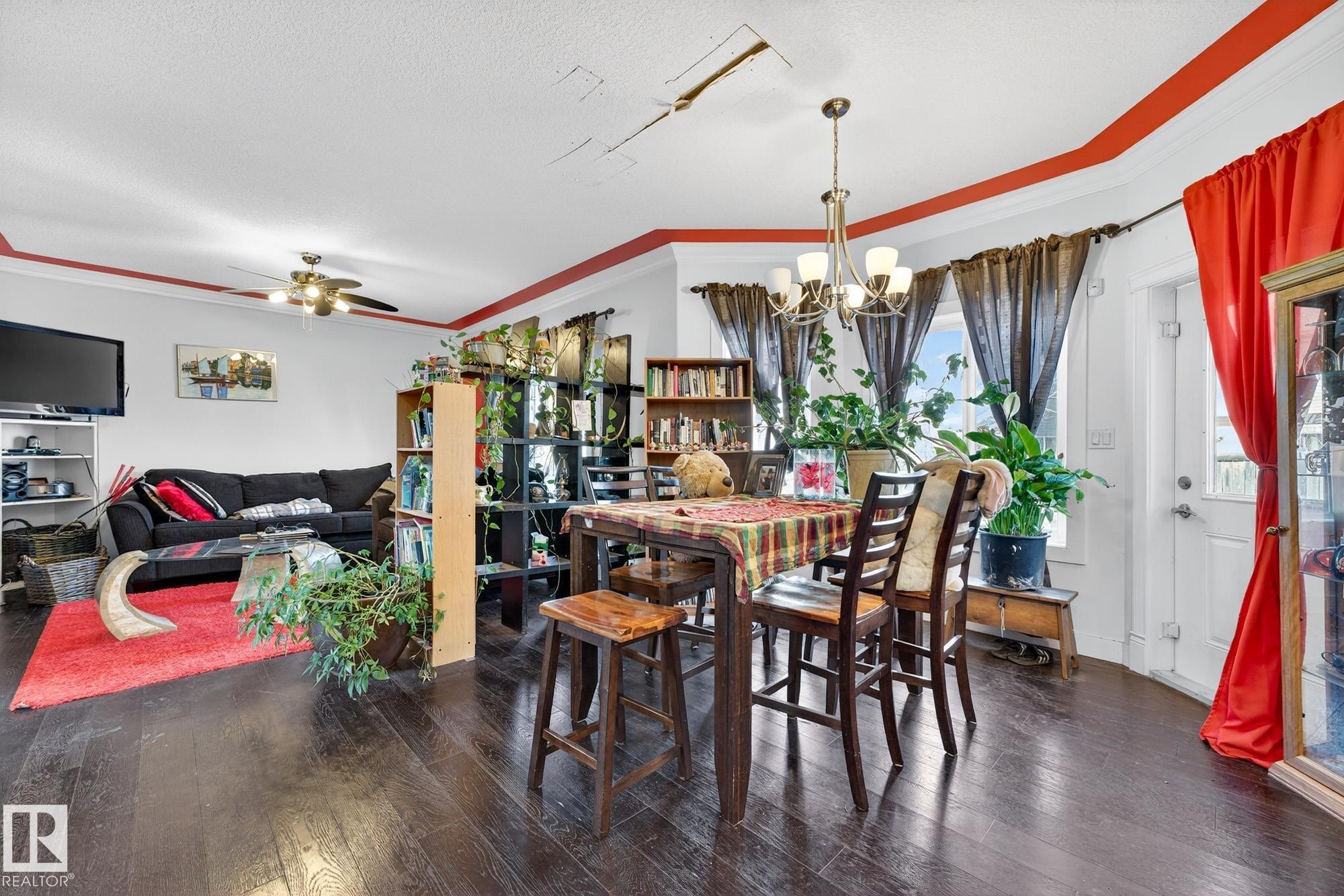 Dining space featuring hardwood / wood-style floors, hanging lights, ceiling fan, and crown molding - 1660 Malone Way, Edmonton, AB - Indoor