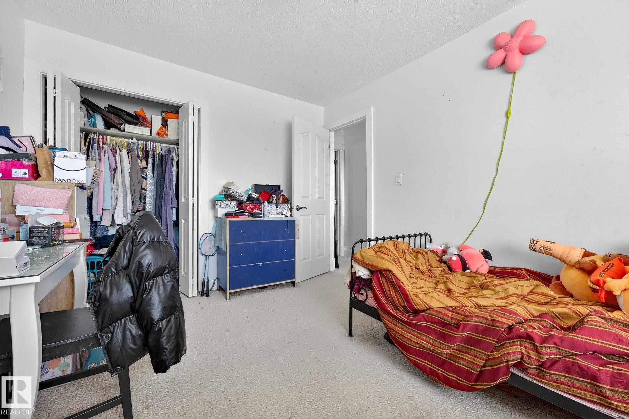 Bedroom with light colored carpet, a closet, and a desk - 1660 Malone Way, Edmonton, AB - Indoor Photo Showing Bedroom