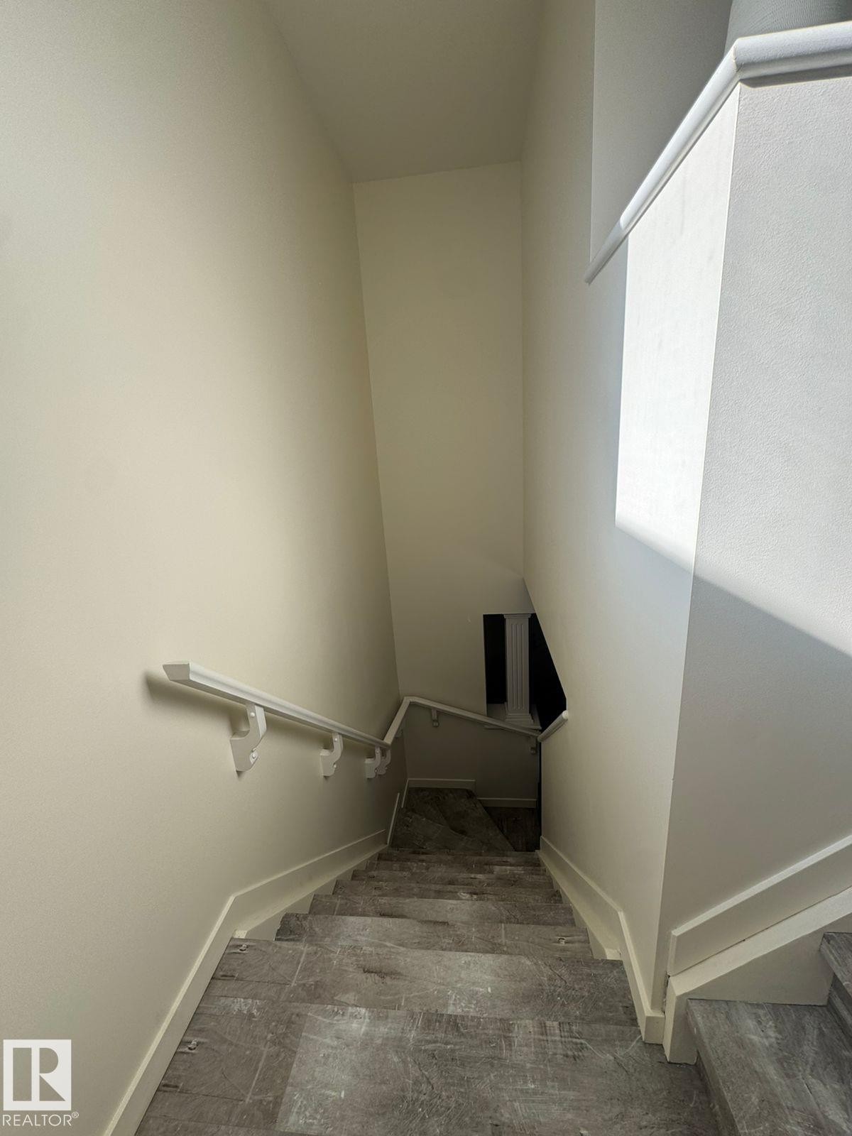 Stairway with baseboards - 17703 65 Street, Edmonton, AB - Indoor Photo Showing Other Room