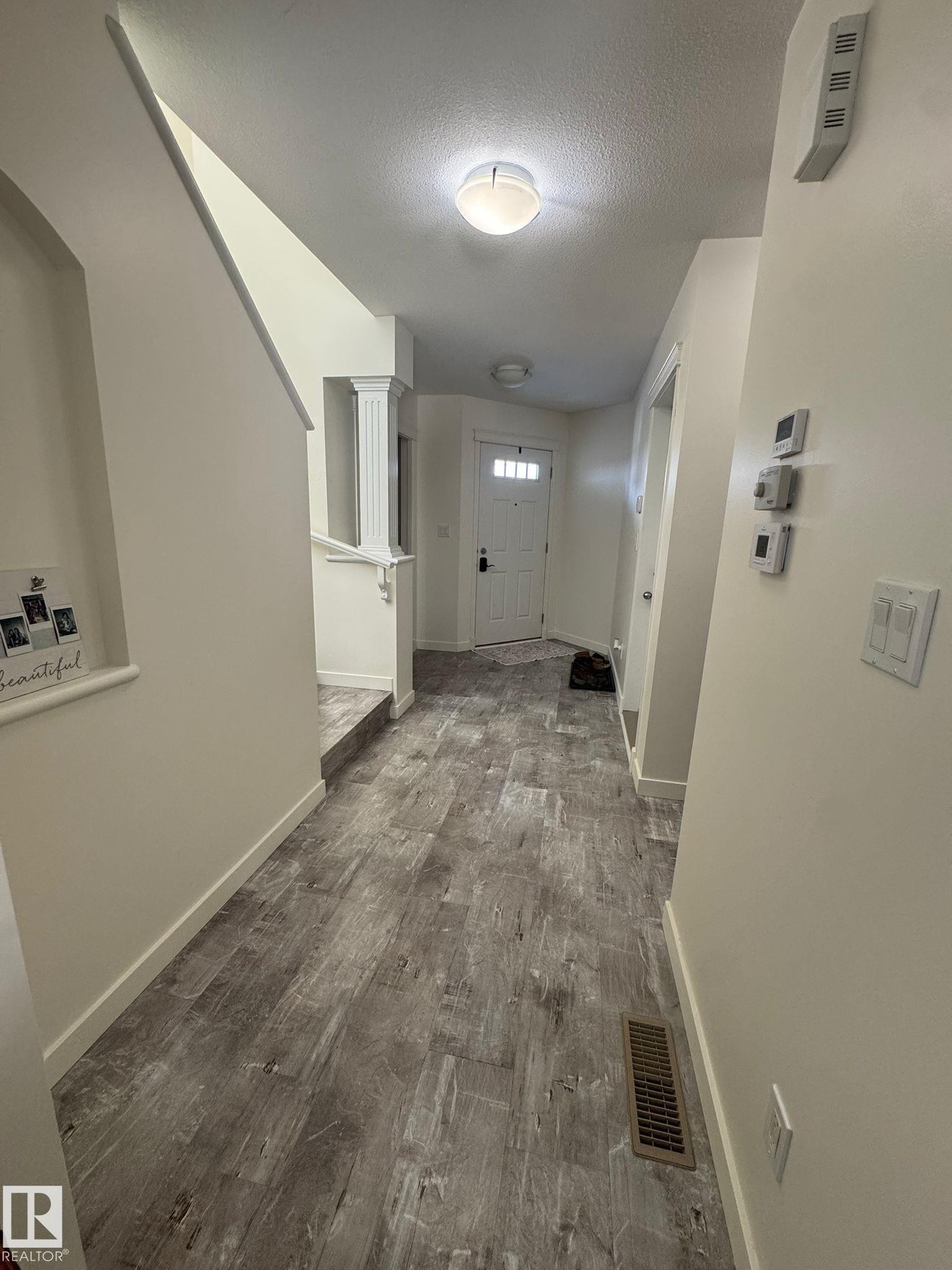 Hall featuring dark wood finished floors and a textured ceiling - 17703 65 Street, Edmonton, AB - Indoor Photo Showing Other Room