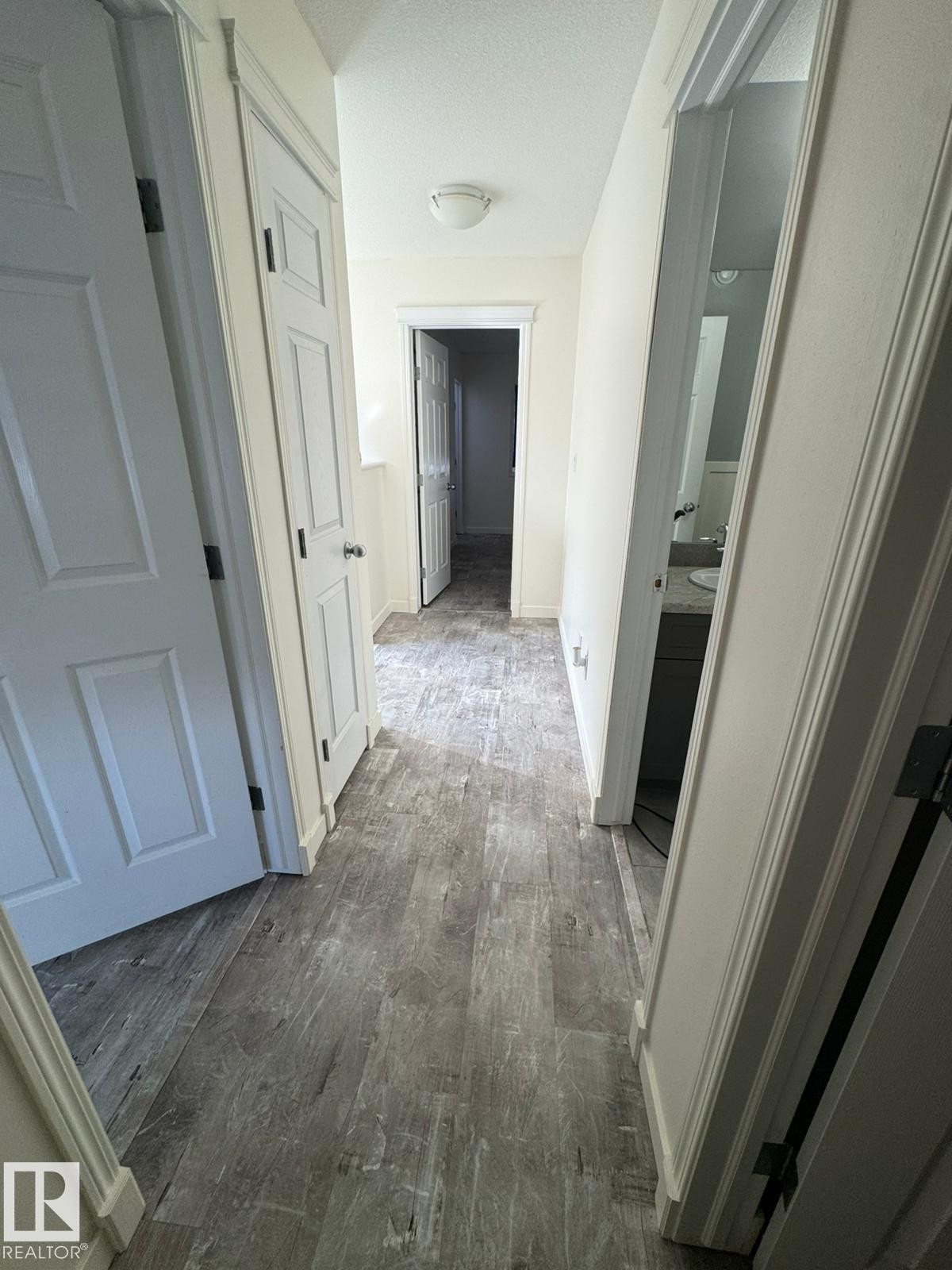 Corridor featuring dark wood finished floors and a textured ceiling - 17703 65 Street, Edmonton, AB - Indoor Photo Showing Other Room