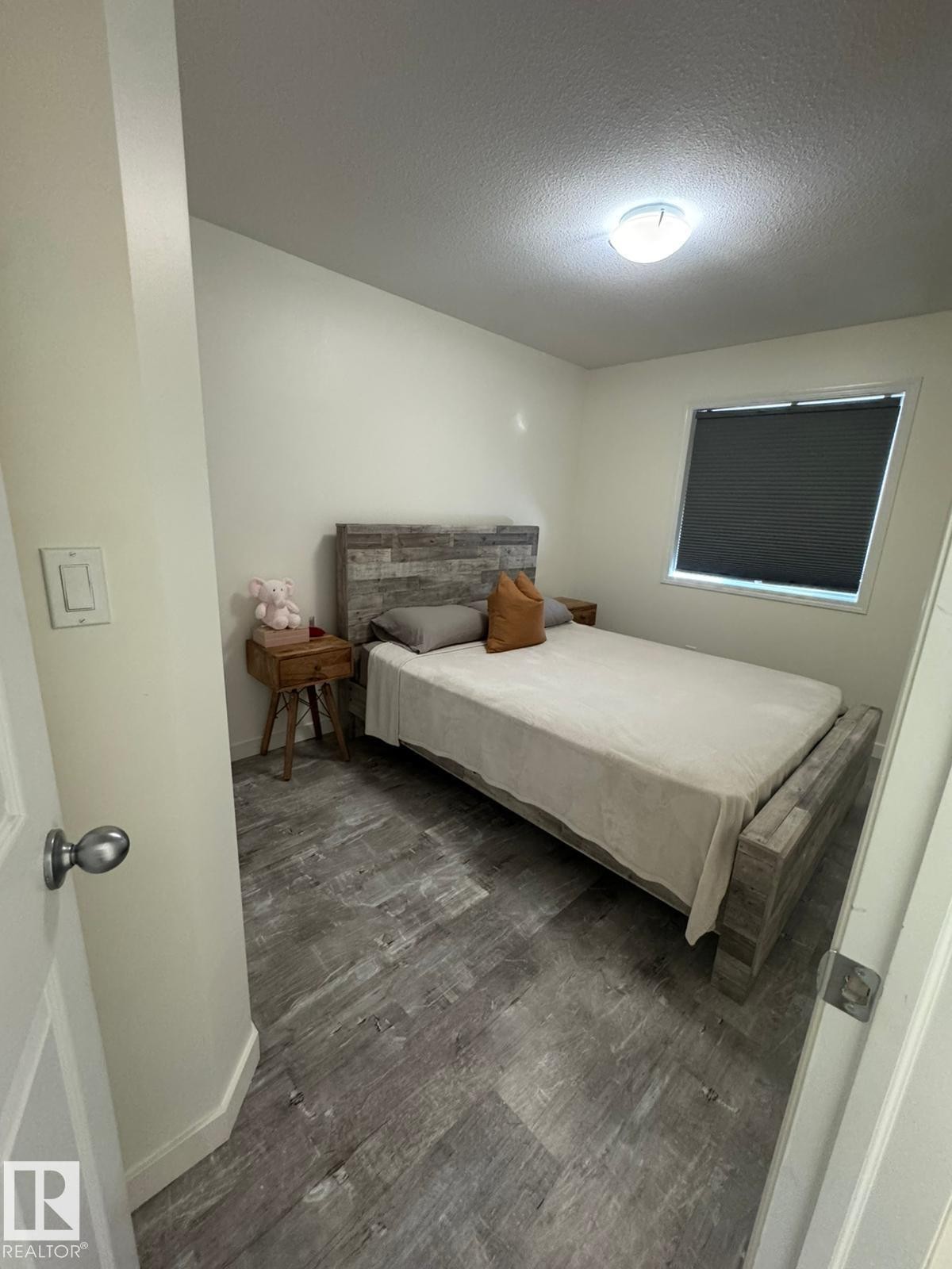 Bedroom featuring dark wood-type flooring and a textured ceiling - 17703 65 Street, Edmonton, AB - Indoor Photo Showing Bedroom