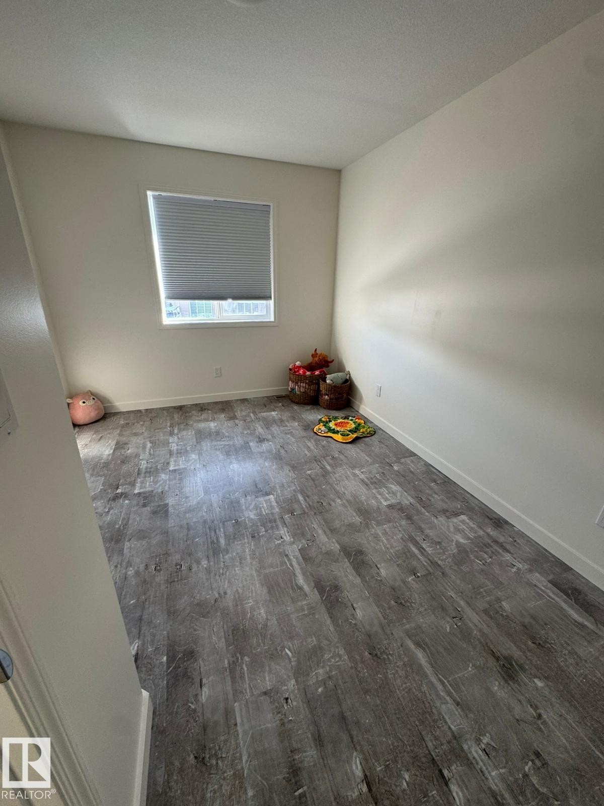 Spare room featuring dark wood finished floors and a textured ceiling - 17703 65 Street, Edmonton, AB - Indoor Photo Showing Other Room