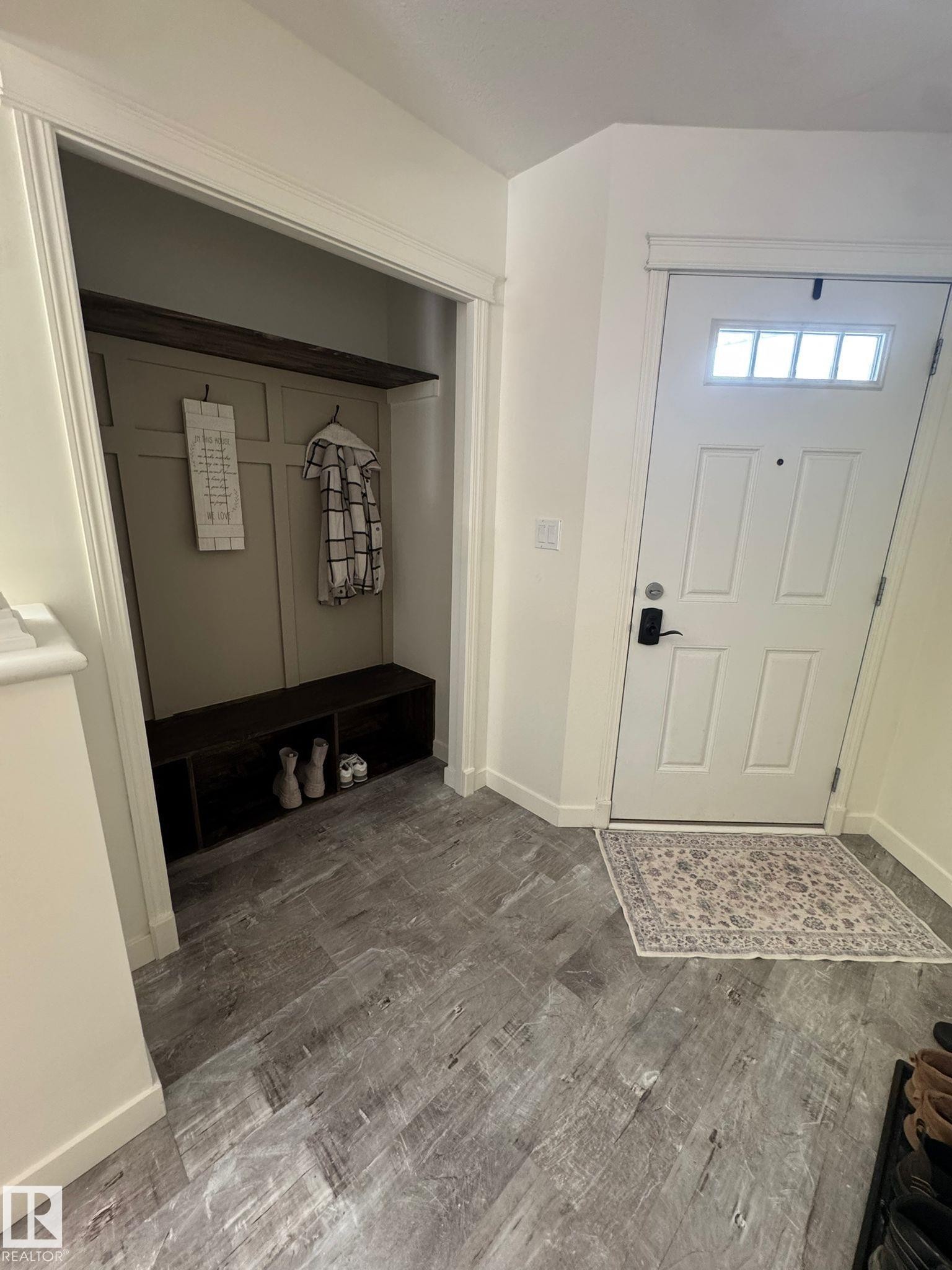 Entrance foyer with baseboards and light wood finished floors - 17703 65 Street, Edmonton, AB - Indoor Photo Showing Other Room