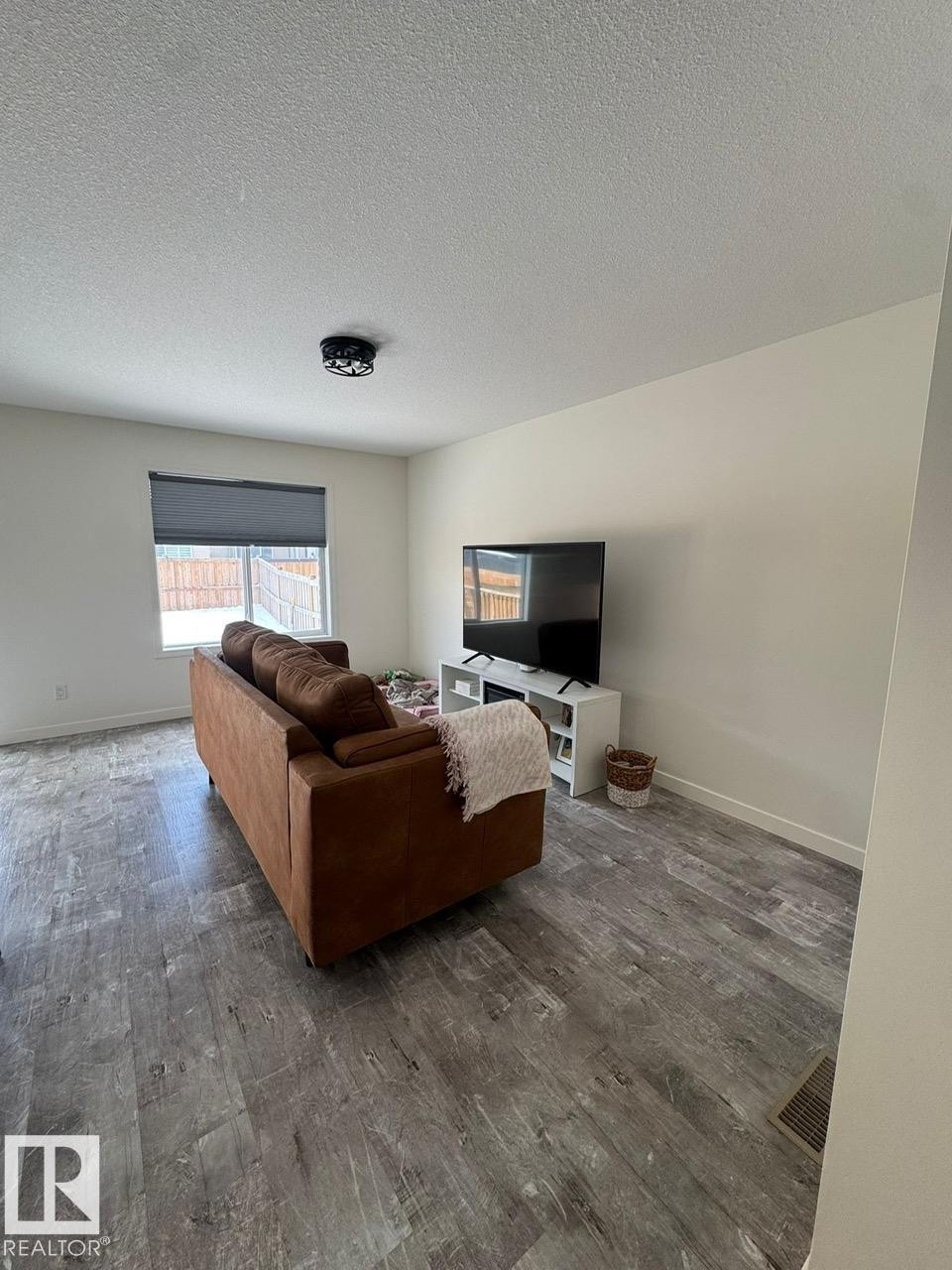 Living room with wood finished floors and a textured ceiling - 17703 65 Street, Edmonton, AB - Indoor