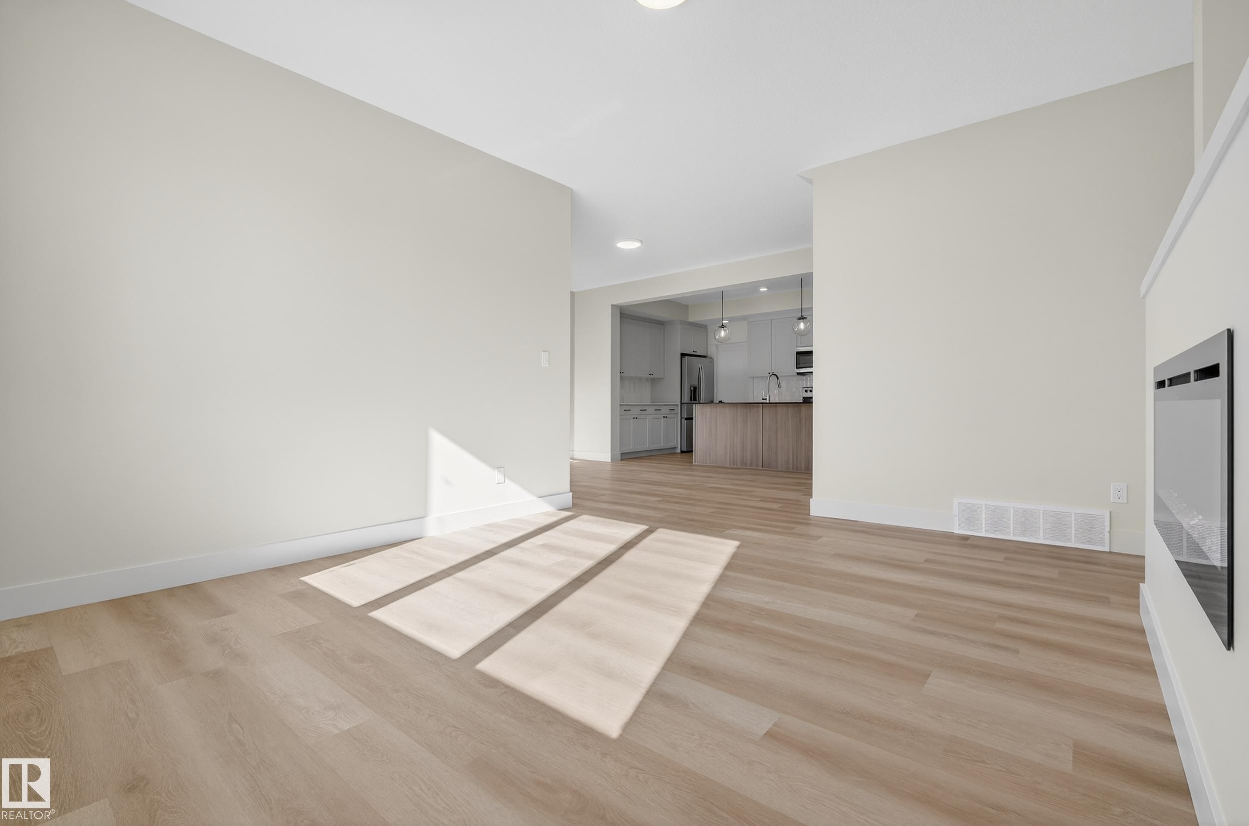 Unfurnished living room with light wood finished floors - 22 Grayson Green, Stony Plain, AB - Indoor Photo Showing Other Room