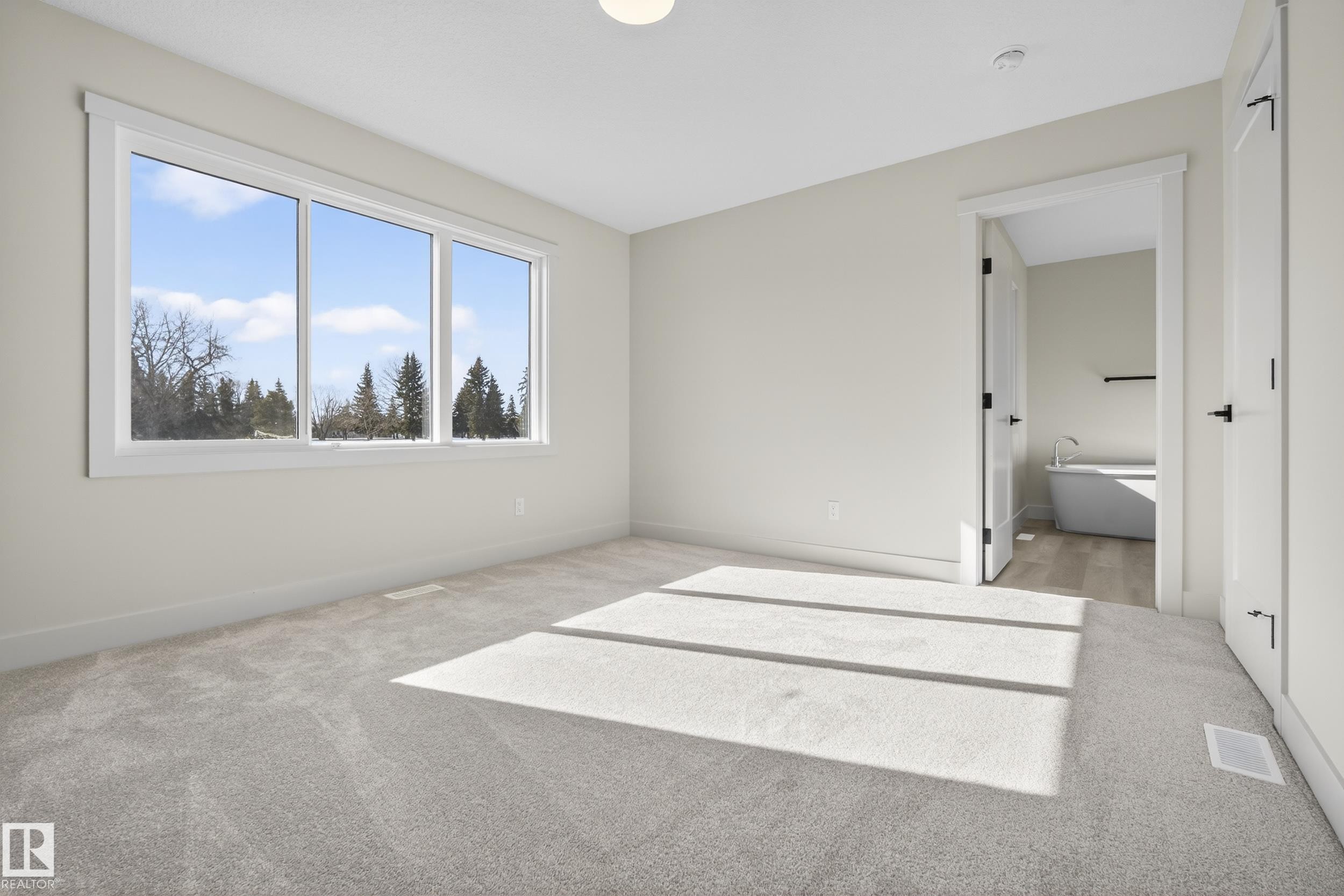 Unfurnished bedroom featuring light colored carpet and ensuite bath - 22 Grayson Green, Stony Plain, AB - Indoor
